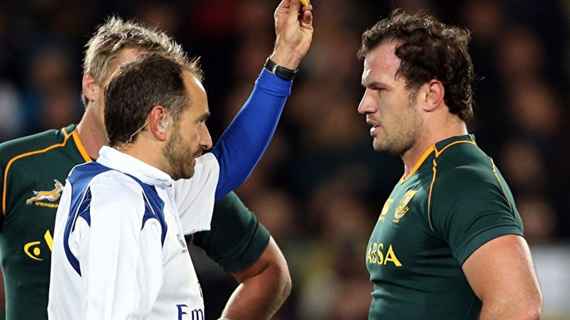 Bismarck du Plessis of South Africa (R) is yellow-carded by referee Romain Poite (L) during the Rugby Championship Test rugby union match between the New Zealand All Blacks and South Africa at Eden Park in Auckland on September 14, 2013.
