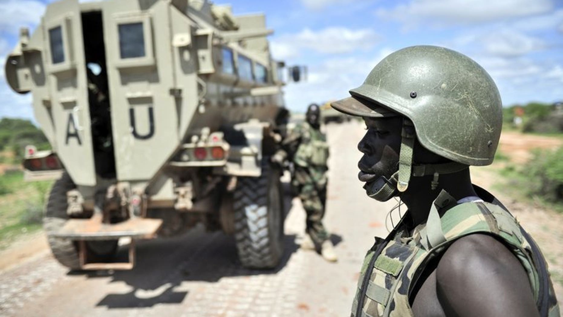 Ugandan soldiers, part of the African Union Mission in Somalia (AMISOM), patrol along the Afgooye-Baidoa road in Somalia on October 19, 2012. Uganda said it had suspended 24 of its army officers, who were part of a UN-mandated force battling Al-Qaeda linked rebels in Somalia, over corruption allegations.
