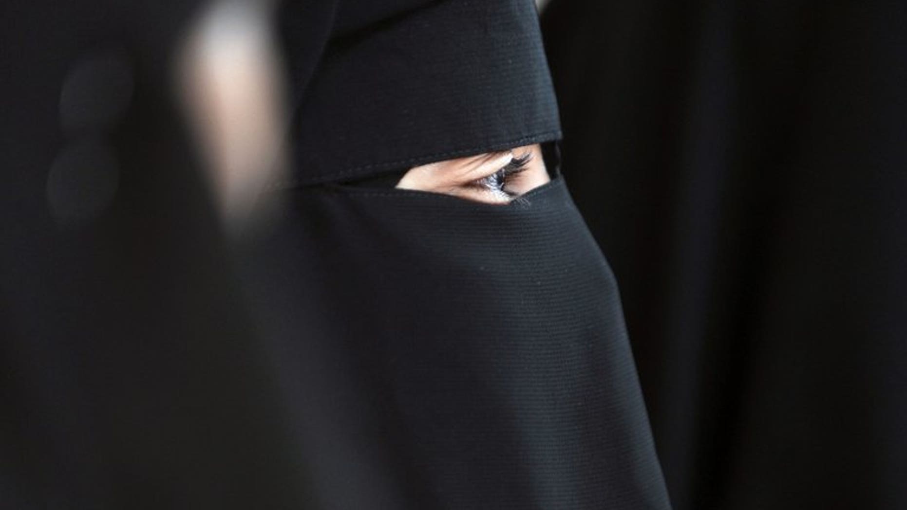 File picture shows a Muslim woman wearing the niqab -- a full-face veil which covers the body and leaves only a small strip for the eyes -- in Montreuil near Paris, on May 18, 2010. A Muslim woman will be allowed to go on trial in Britain wearing a niqab but must take it off while giving evidence, thought to be a legal first, a judge ruled Monday.