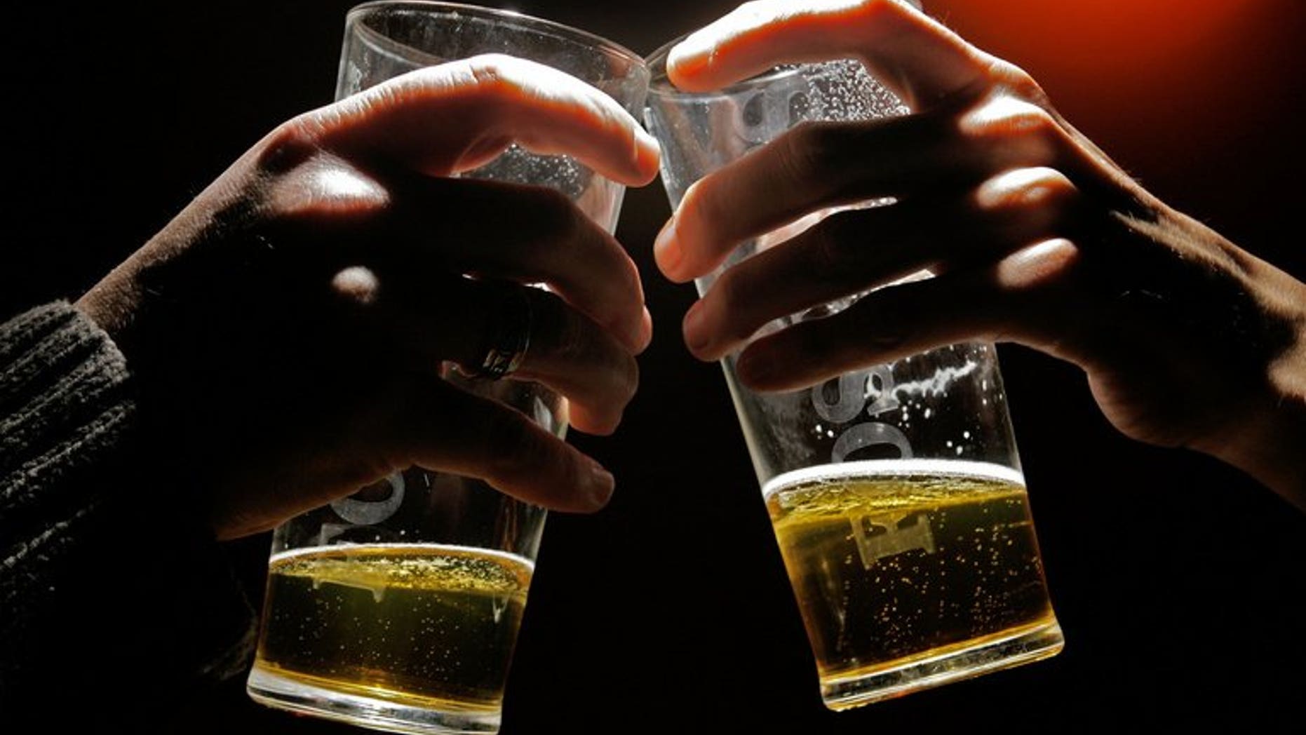 People drink beer at a London pub on November 23, 2005. Inebriated individuals causing nuisance should be lodged in privately-run drunk tanks and made to pay for their care, police chiefs said on Wednesday.