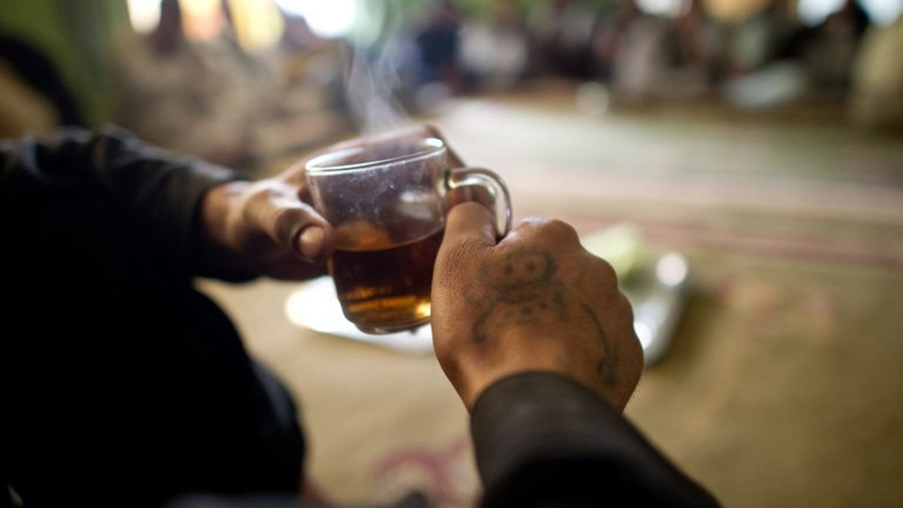 A man drinks tea in Kabul on April 24, 2012. An Indian court has reprimanded police for arresting a man they accused of drinking tea in a "suspicious" manner at one of the country's ubiquitous roadside stalls.