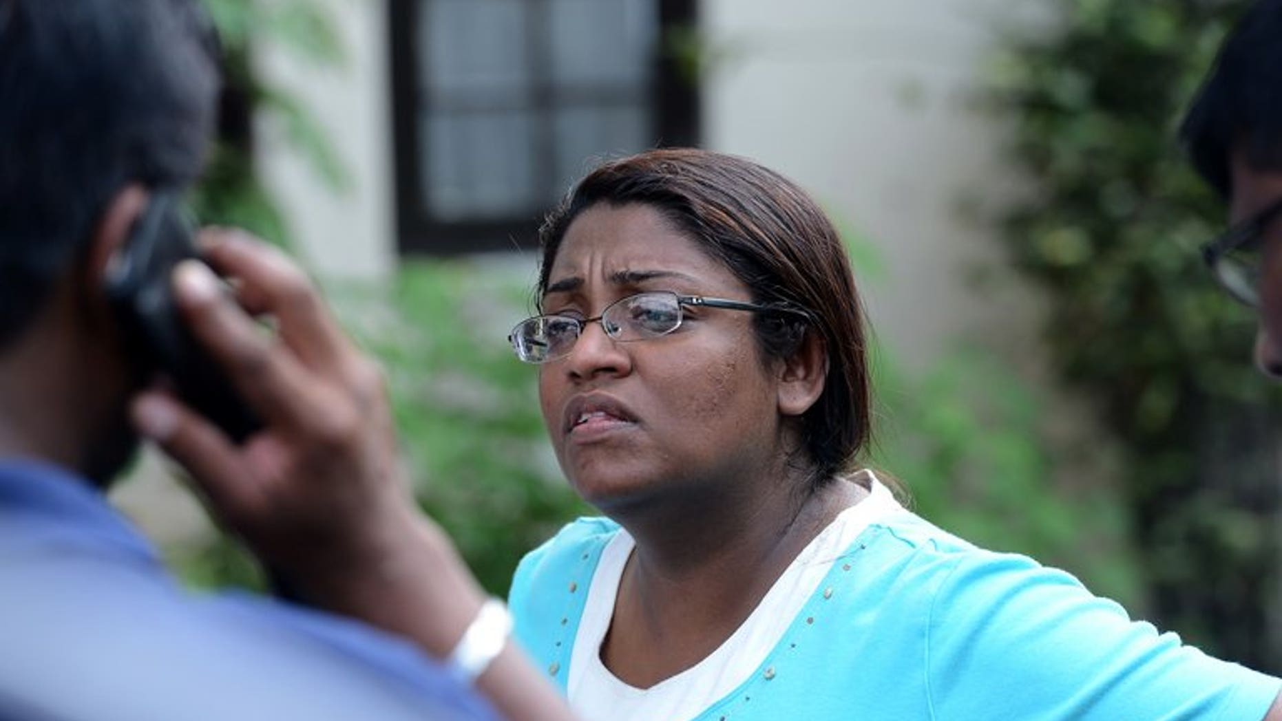 In this photograph taken on August 24, 2013, Sri Lankan editor Mandana Ismail Abeywickrema speaks with colleagues in Colombo. Abeywickrema has fled the country following death threats and an armed attack on her home in Colombo, according to a media rights group.