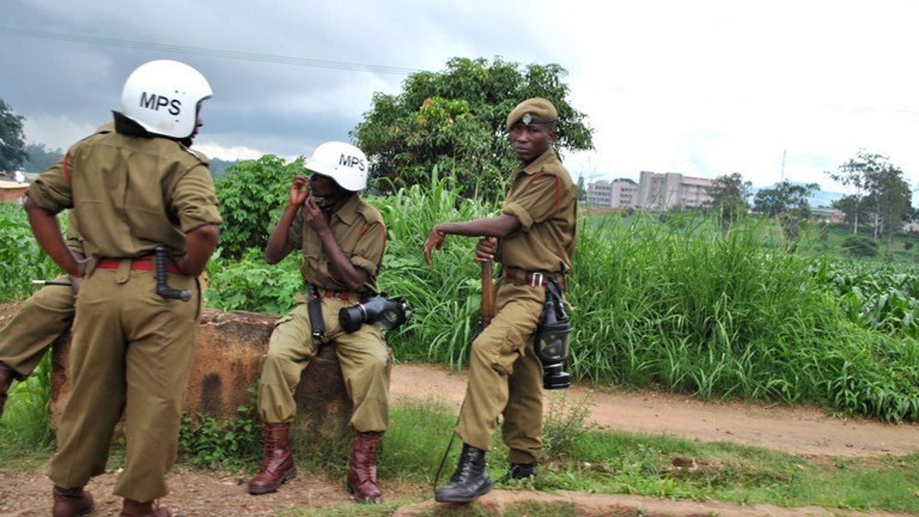 Police officers rest near a market in Blantyre on January 17, 2013. Malawi police said they have arrested three suspects in connection with the shooting of a top treasury official about to expose a corruption syndicate.