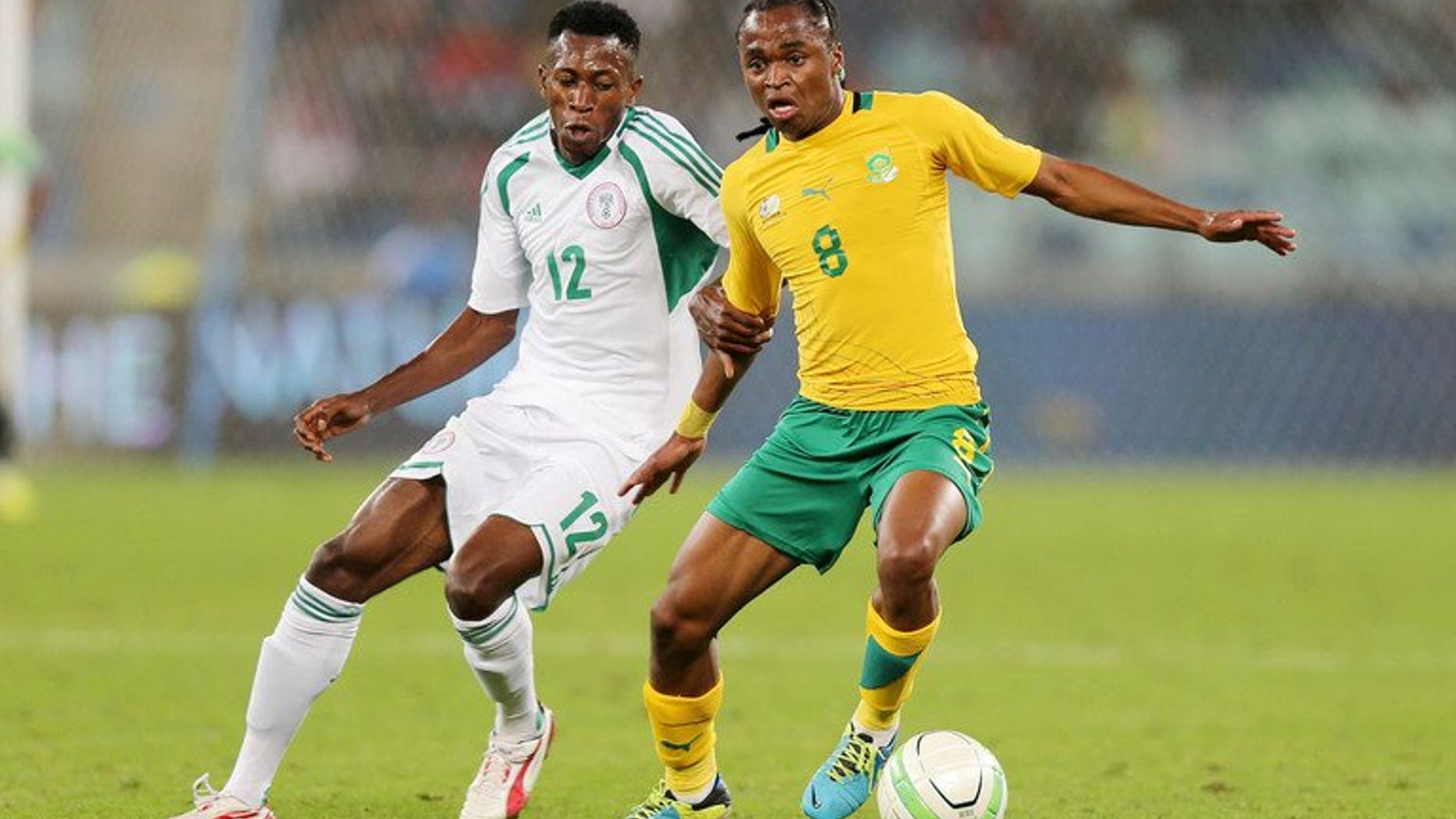 Nigeria's Namdi Ouduamadi challenges Siphiwe Tsabalala of South Africa in a friendly in Durban last month. Major rivals South Africa and Nigeria were drawn together on Wednesday in the first round of the 2014 African Nations Championship (CHAN).
