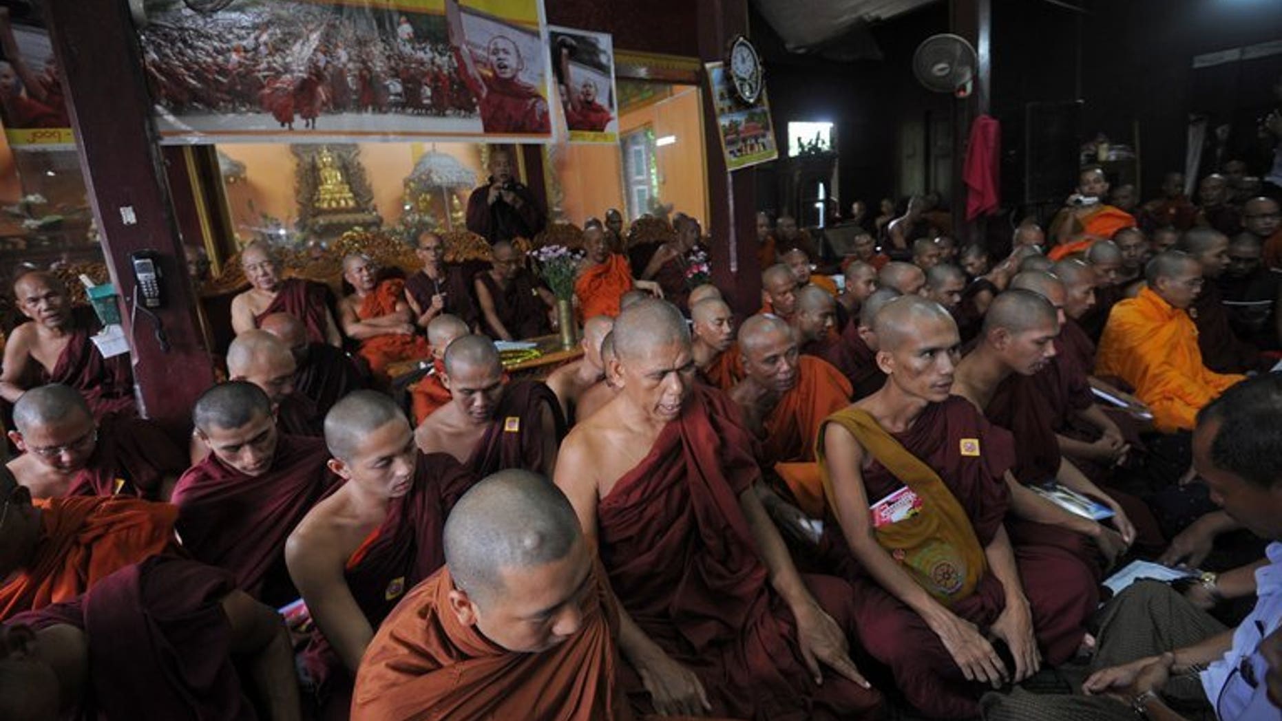 Myanmar Buddhist monks pray during a gathering to mark the sixth anniversary of "Saffron Revolution" at a monastery in Yangon on September 18, 2013.