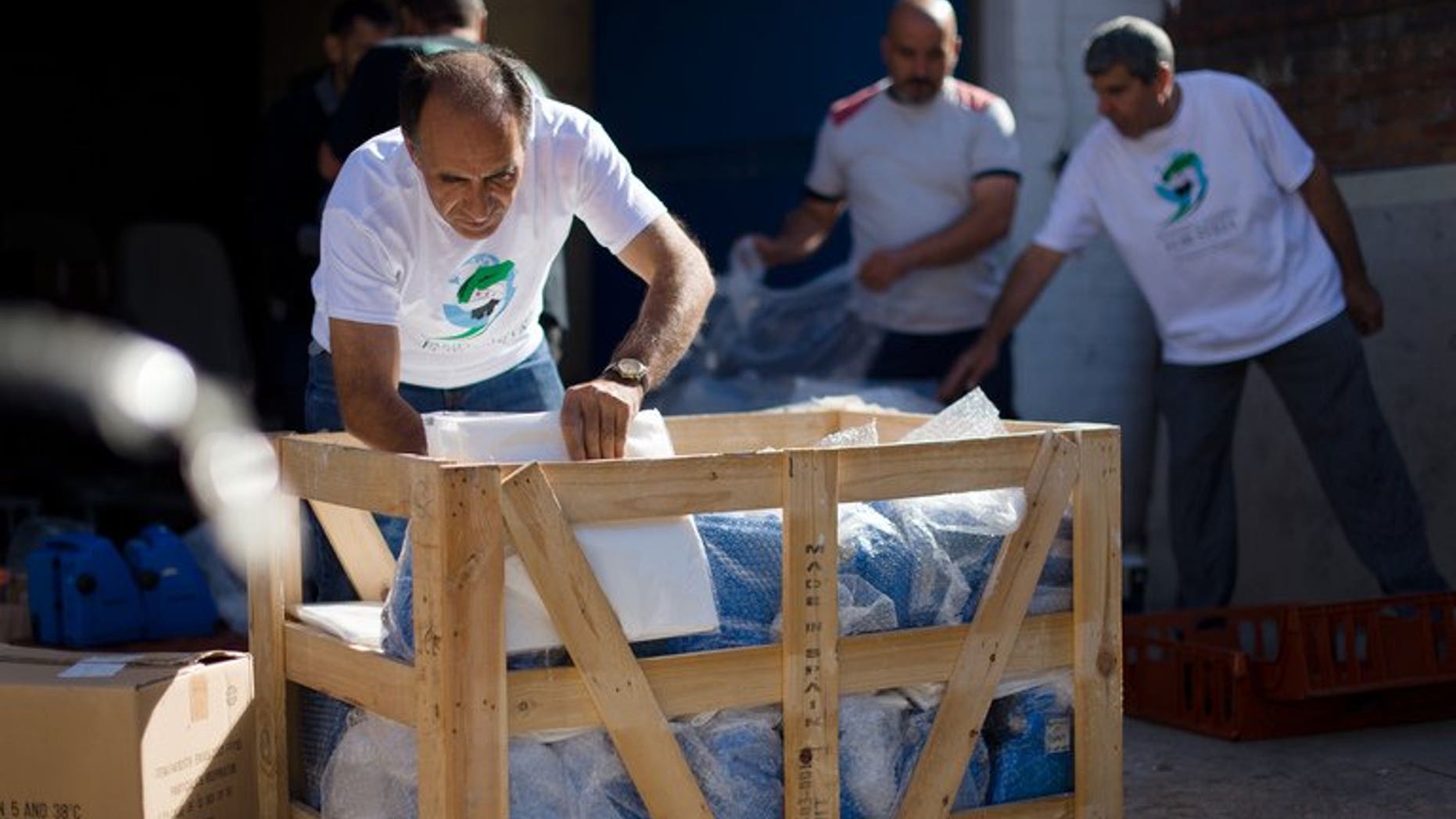Volunteers move medical equipment at a "Hand in Hand for Syria" collection point in north London on August 31, 2013. Donor countries are failing to adequately fund the humanitarian response to the Syrian crisis, the aid agency Oxfam said on Thursday.