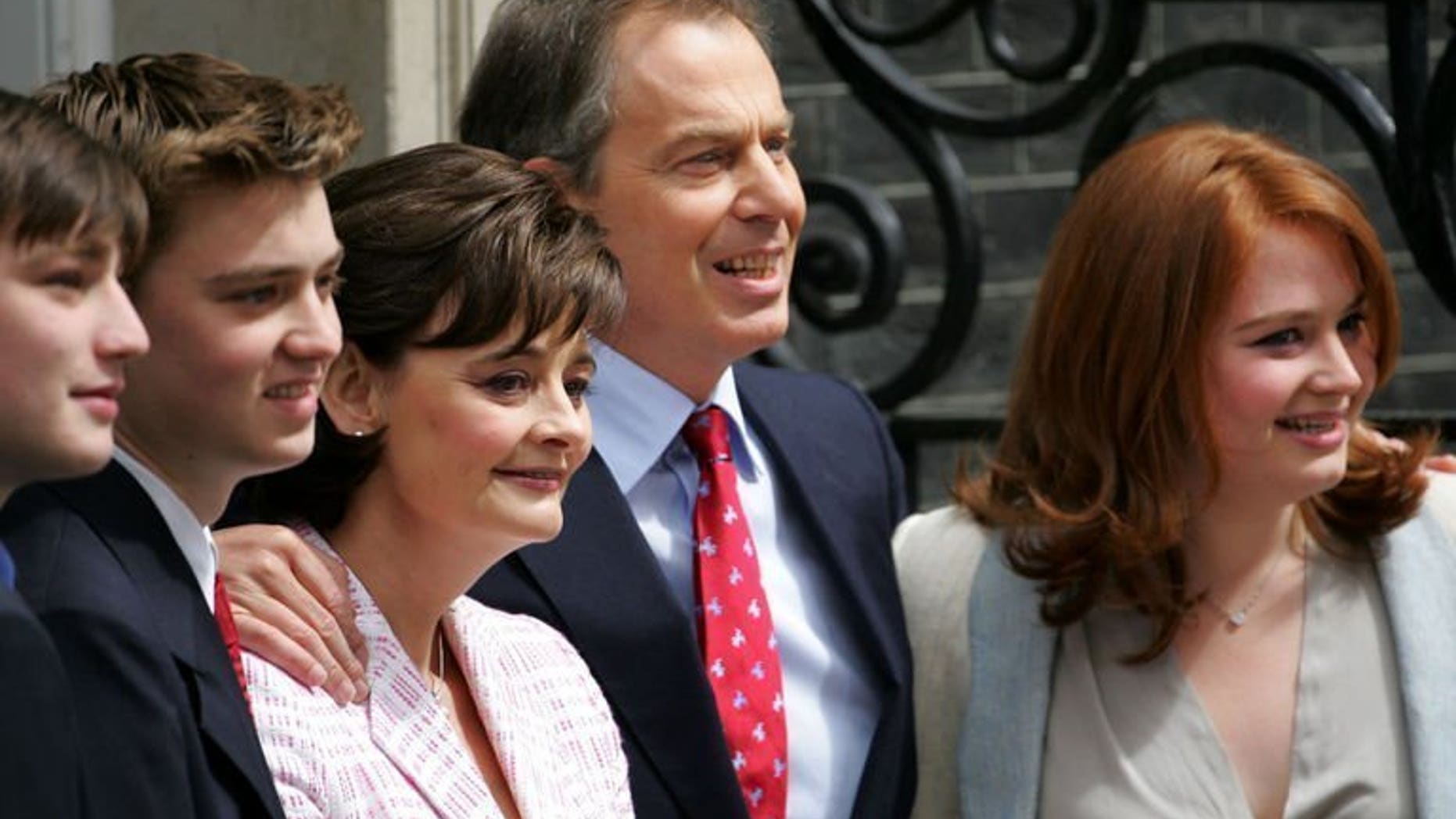 Then British Prime Minister Tony Blair stands with his sons Nicky (L), Euan (2nd L), wife Cherie and daughter Kathryn (R) at 10 Downing Street in London on May 6, 2005. Kathryn Blair has been held at gunpoint in an attempted armed robbery in central London.