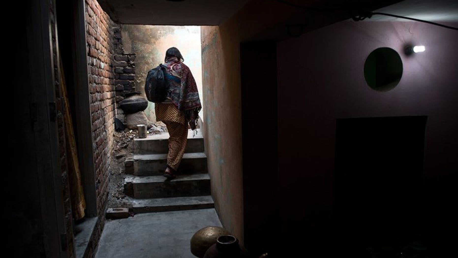 A woman walks up stairs in Haryana state, India, on January 23, 2013. A man was beheaded and his girlfriend beaten to death in an "honour killing" in northern India after they eloped, police said Thursday.
