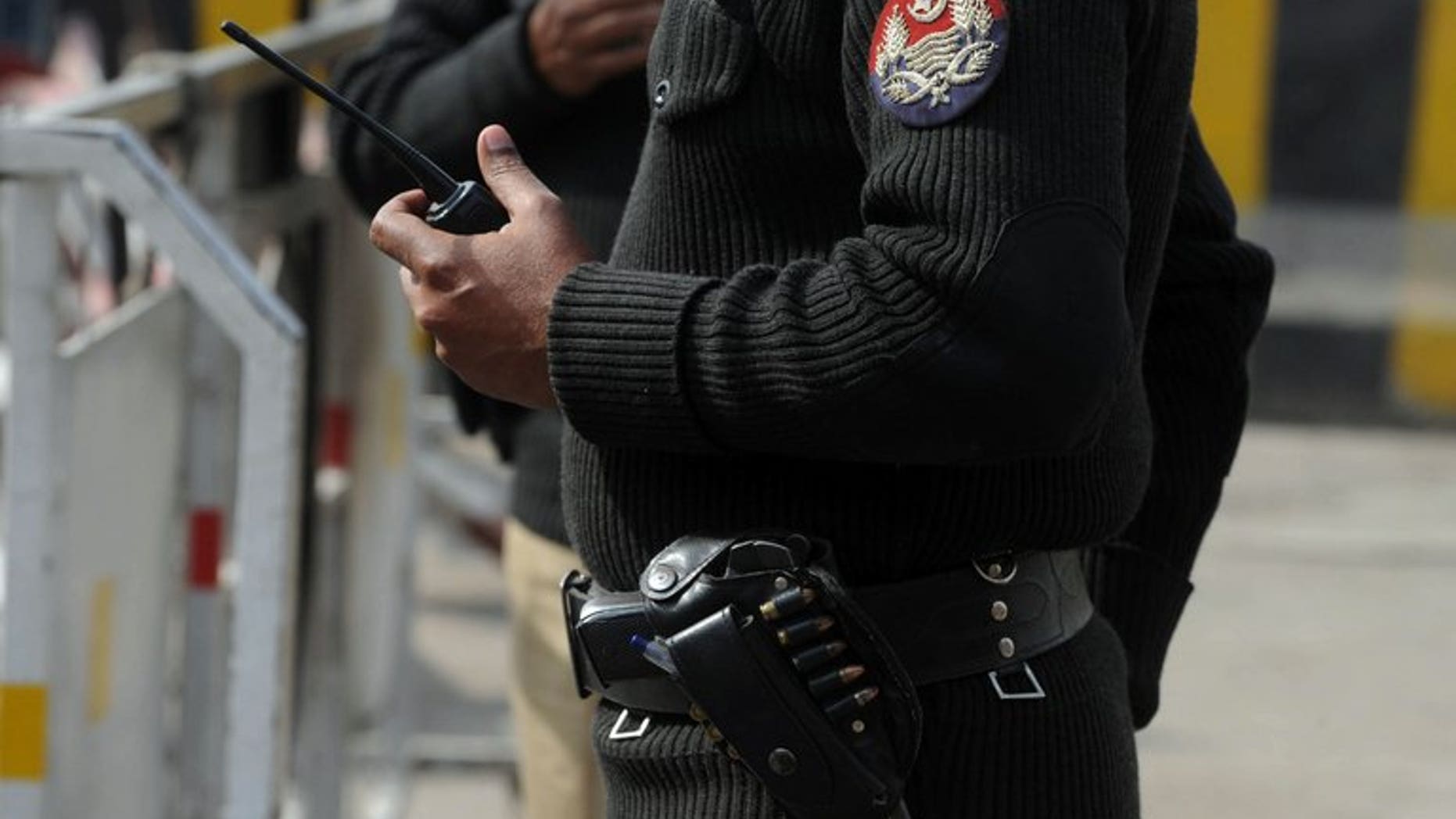 Pakistani police patrol on a street in Lahore on February 2, 2012. Pakistani police have arrested eight people after three men accused of serious crimes were made to walk over hot coals in a 'trial by fire' ritual to prove their innocence.