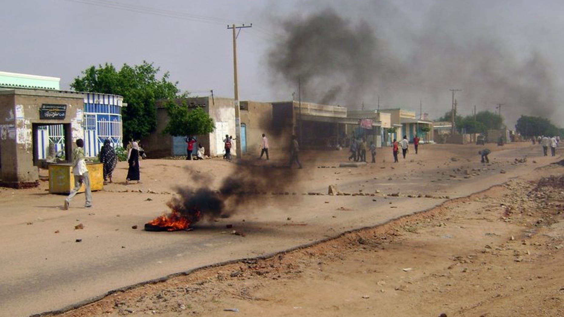 Smoke billows from burning tyres as Sudanese demonstrators protest in Nyala on July 31, 2012. Thousands of angry demonstrators in the South Darfur state capital Nyala clashed with police as they protested the murder of a businessman a day earlier