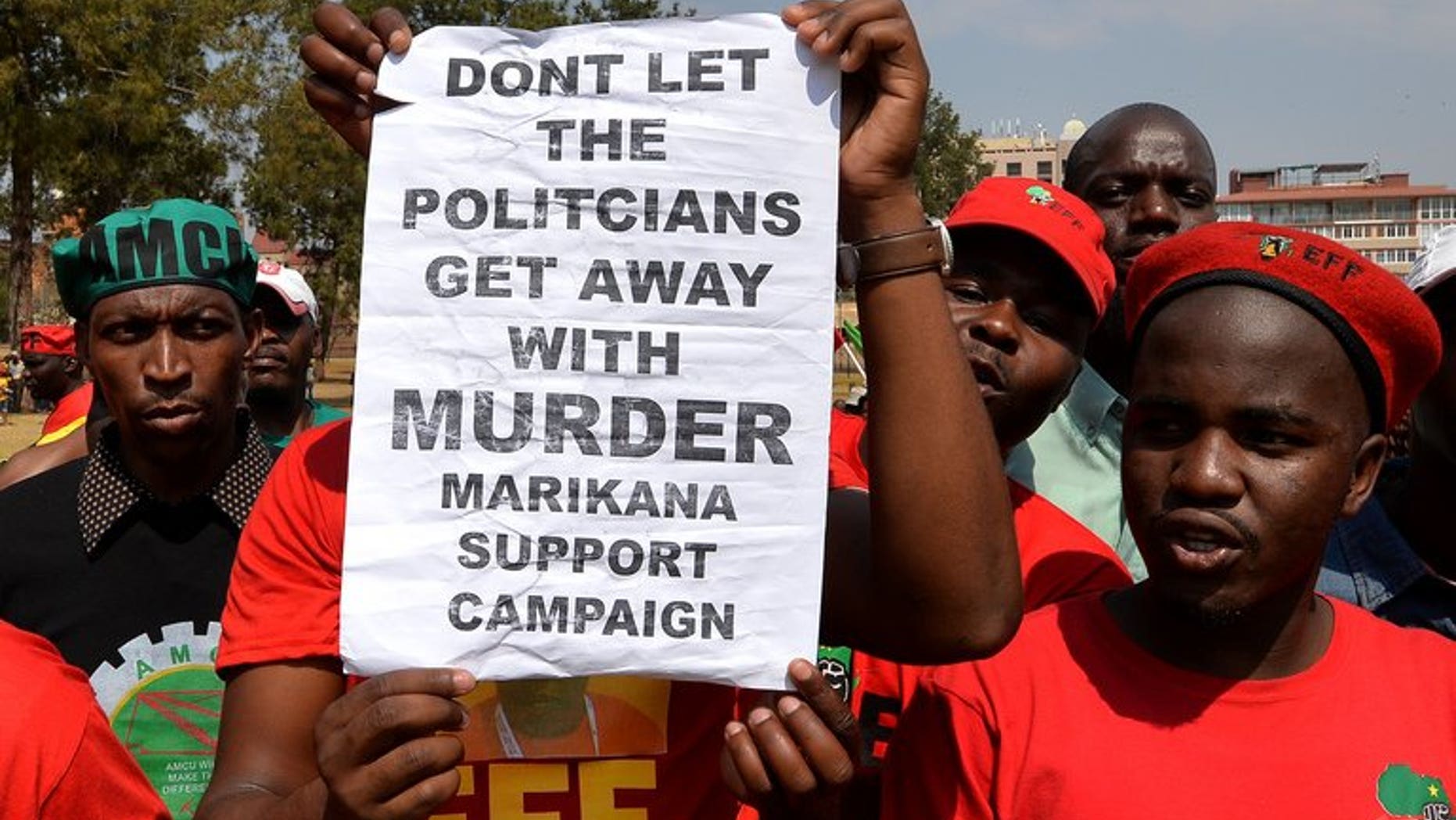 Minners march on South African government buildings in Pretoria on September 12, 2013. A South African commission of inquiry said Thursday that the police lied about the shooting dead of 34 striking miners last year, in a searing criticism of police conduct.