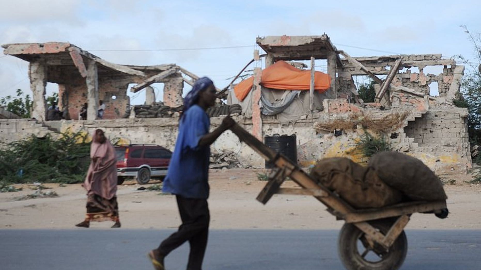 A man carts sacks of charcoal in Mogadishu on April 23, 2013.
