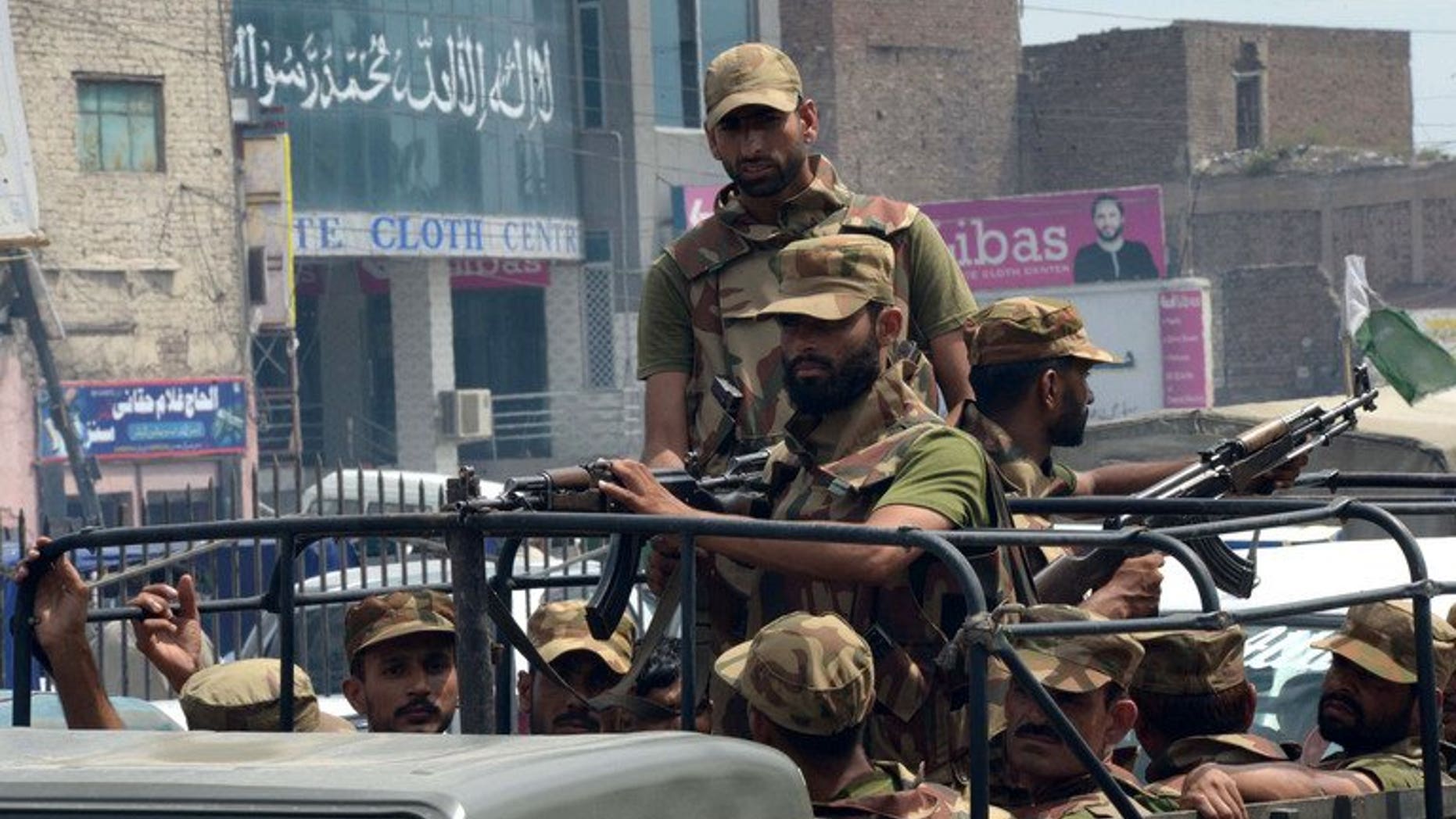 Pakistani soldiers patrol in Peshawar in August. Suspected militants on a motorbike threw grenades at a mosque in the northwestern city of Peshawar, killing at least three Islamic preachers and wounding 18 others.