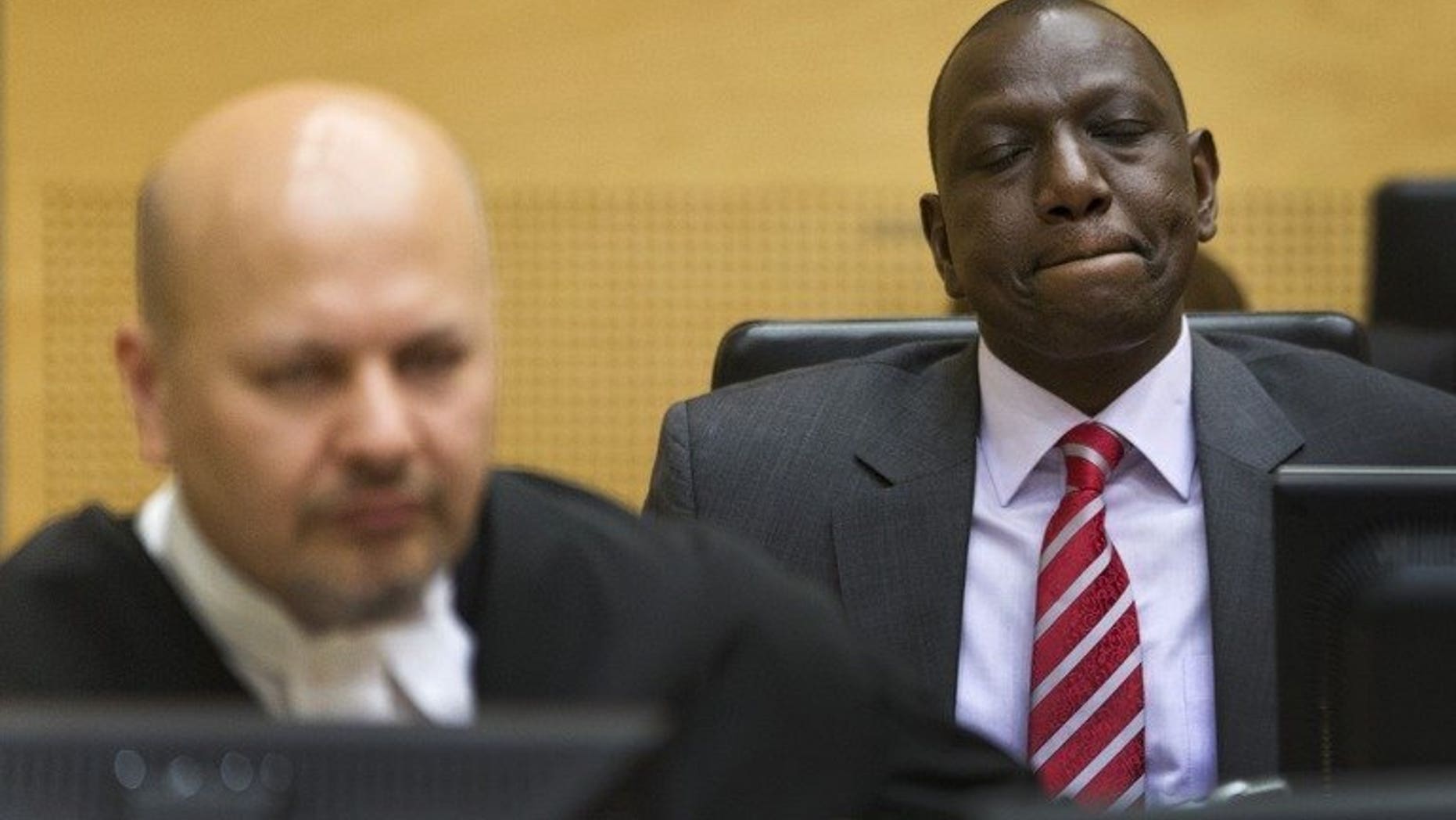 Kenya's Deputy President William Ruto (right) reacts as he sits in the courtroom before their trial at the International Criminal Court (ICC) in The Hague on September 10, 2013. African leaders are to hold a special summit next month amid growing opposition to the crimes against humanity trials of Kenya's leadership at the International Criminal Court.