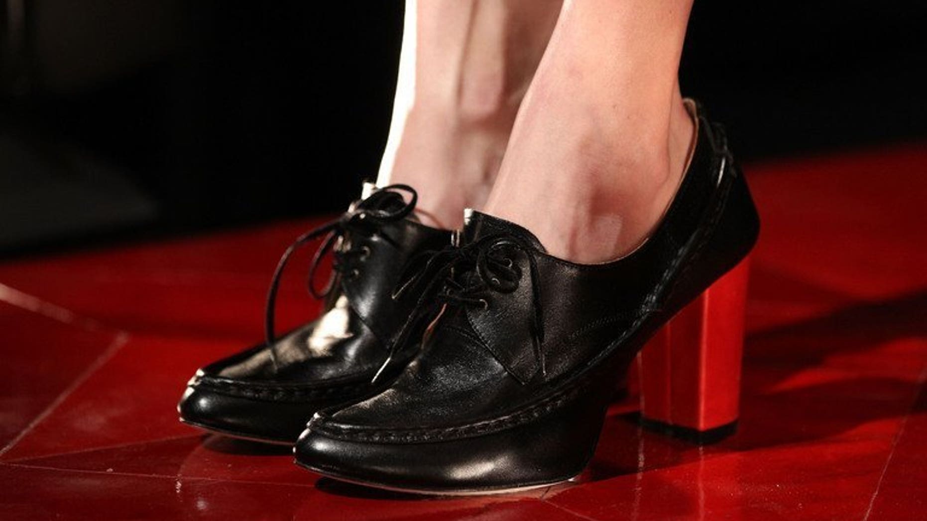 File picture for illustration shows a model wearing shoes on the catwalk at the Leather Japan 2012 Fall 2012 Presentation in New York City on February 13, 2012. A court in Japan Friday jailed a man for slipping corrosive acid into the shoes of a colleague he was stalking, causing her to have the tips of her toes amputated, officials and media reports said.