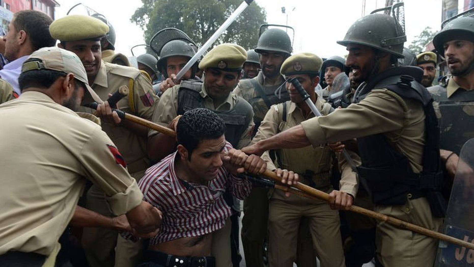 File picture shows Indian police detaining an activist of Kashmir's main opposition Peoples Democratic Party (PDP) during a protest against the killing of a youth in Shopian, near Srinagar on September 13, 2013.