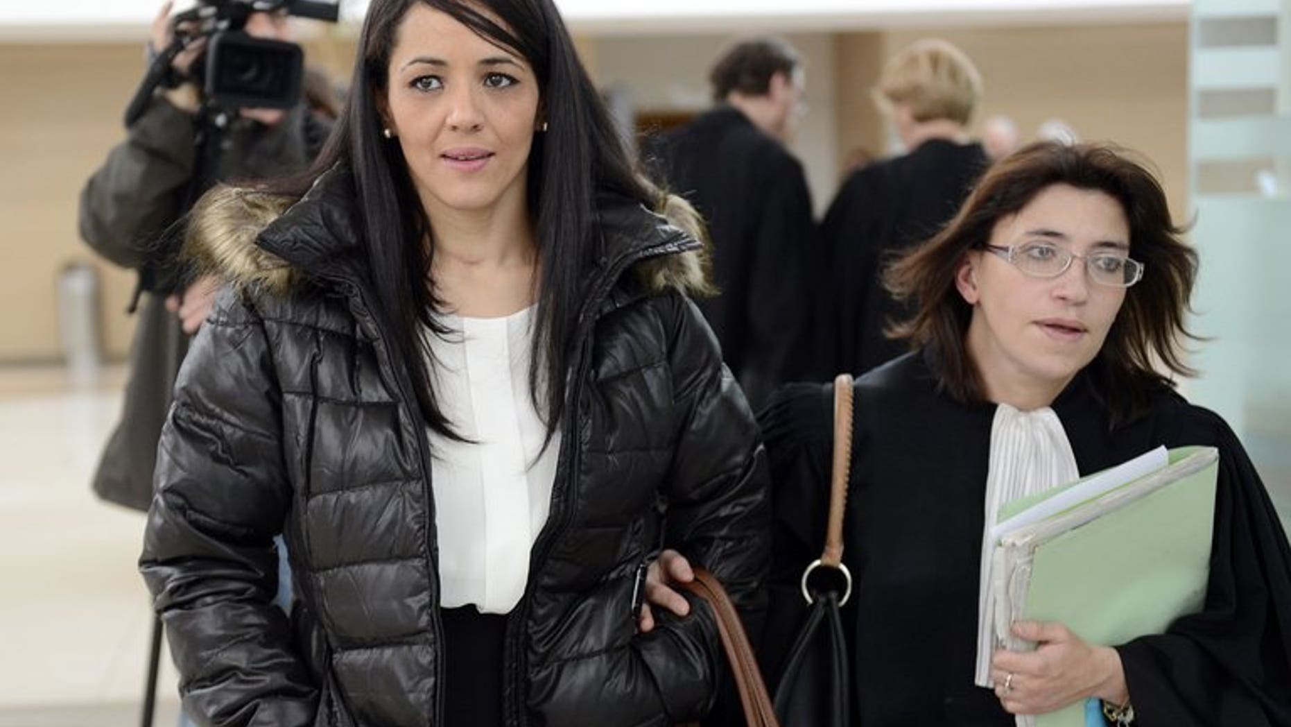 Bouchra Bagour (L), the mother of a boy named Jihad who was born on September 11, leaves Avignon's courthouse in southern France on December 19, 2012, with her lawyer Gaelle Genoun, after her trial for sending her son to school in a T-shirt with "I am a bomb" written on it.