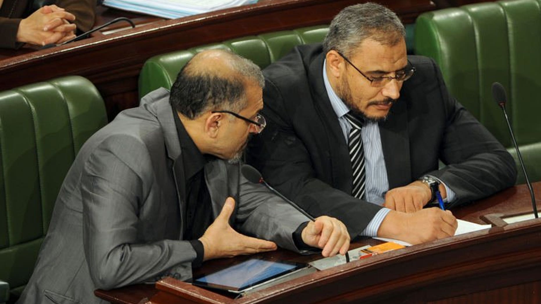 Tunisia's Islamist Prime Minister Ali Larayedh (L) chats with leader of Ennahda's Parliamentary group, Sahbi Atig as they attend a constituent assembly meeting on September 19, 2013.