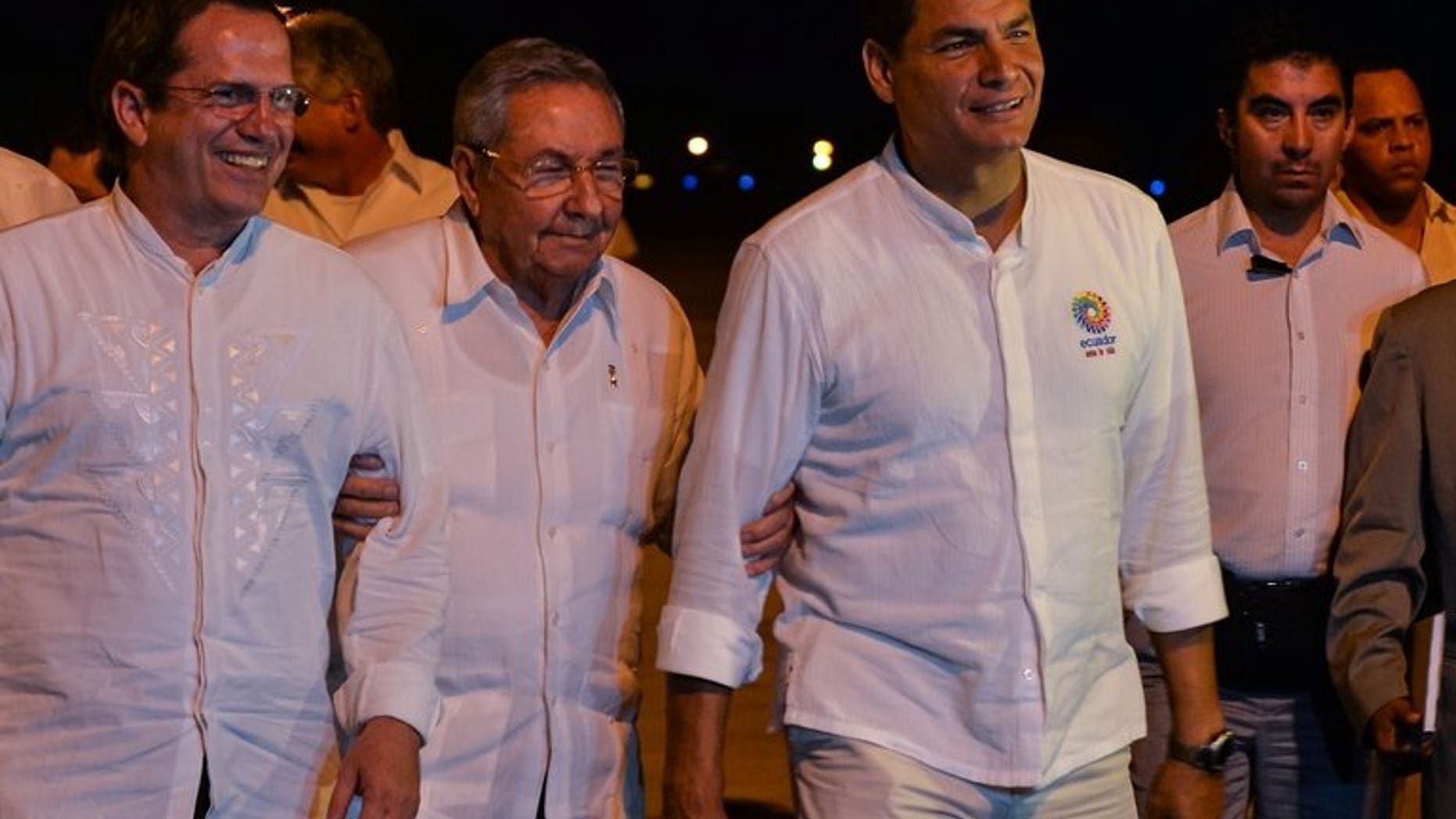 Cuban President Raul Castro (center) is flanked by Ecuadorian counterpart Rafael Correa (right) and Foreign Minister Ricardo Patino at the Jose Marti Airport in Havana, on September 21, 2013. Correa is in Havana to meet Cuban revolutionary leader Fidel Castro and his younger brother Raul Castro.