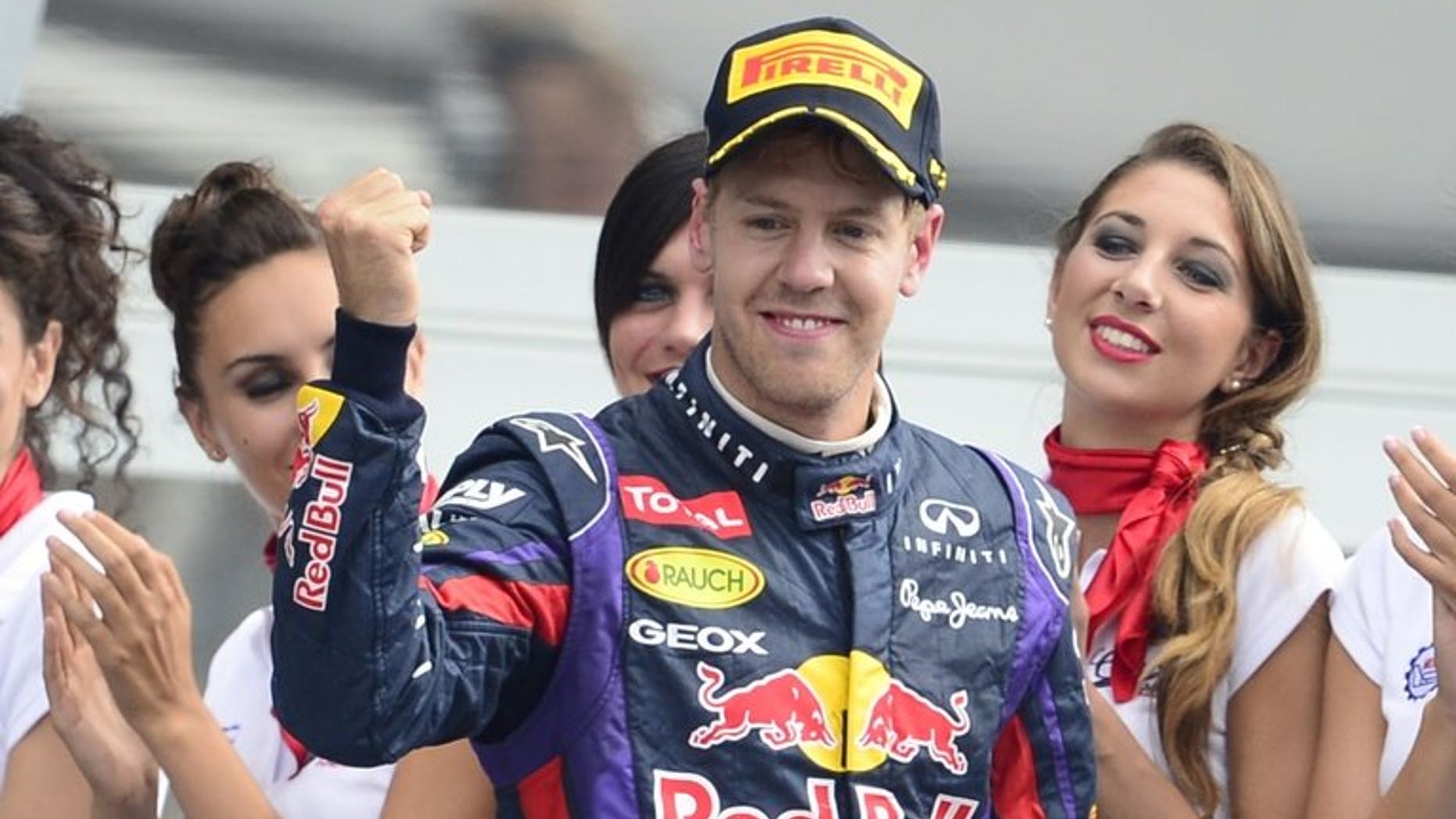 Red Bull Racing's German driver Sebastian Vettel celebrates on the podium at the Autodromo Nazionale circuit in Monza on September 8, 2013 after the Italian Formula One Grand Prix. Vettel has been fined 200 euros ($270) for speeding in the pitlane at the Singapore Grand Prix -- an amount he earns in less than 10 minutes.