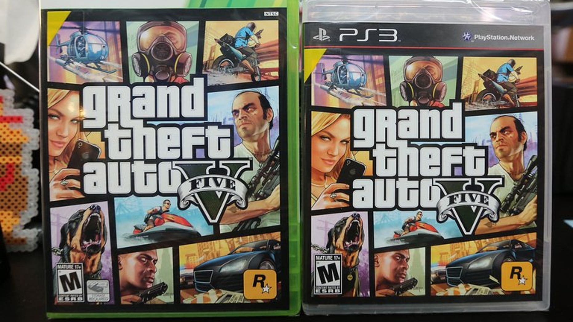 Copies of Grand Theft Auto V displayed at the 8 Bit & Up video game shop in Manhattan's East Village on September 18, 2013 in New York. Three British teenagers have been charged over the stabbing and robbery of a man who was walking home after buying the blockbuster videogame, police said on Saturday.