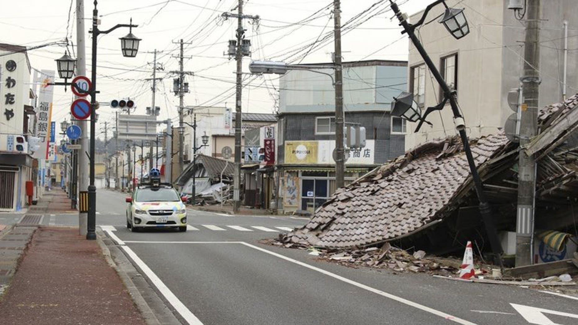 A Google car mounted with a street view camera drives through a street in Namie, on March 28, 2013. namie -- a town abandoned after the Fukushima nuclear accident -- has protested Prime Minister Shinzo Abe's global promise that the situation of the crippled plant was "under control".