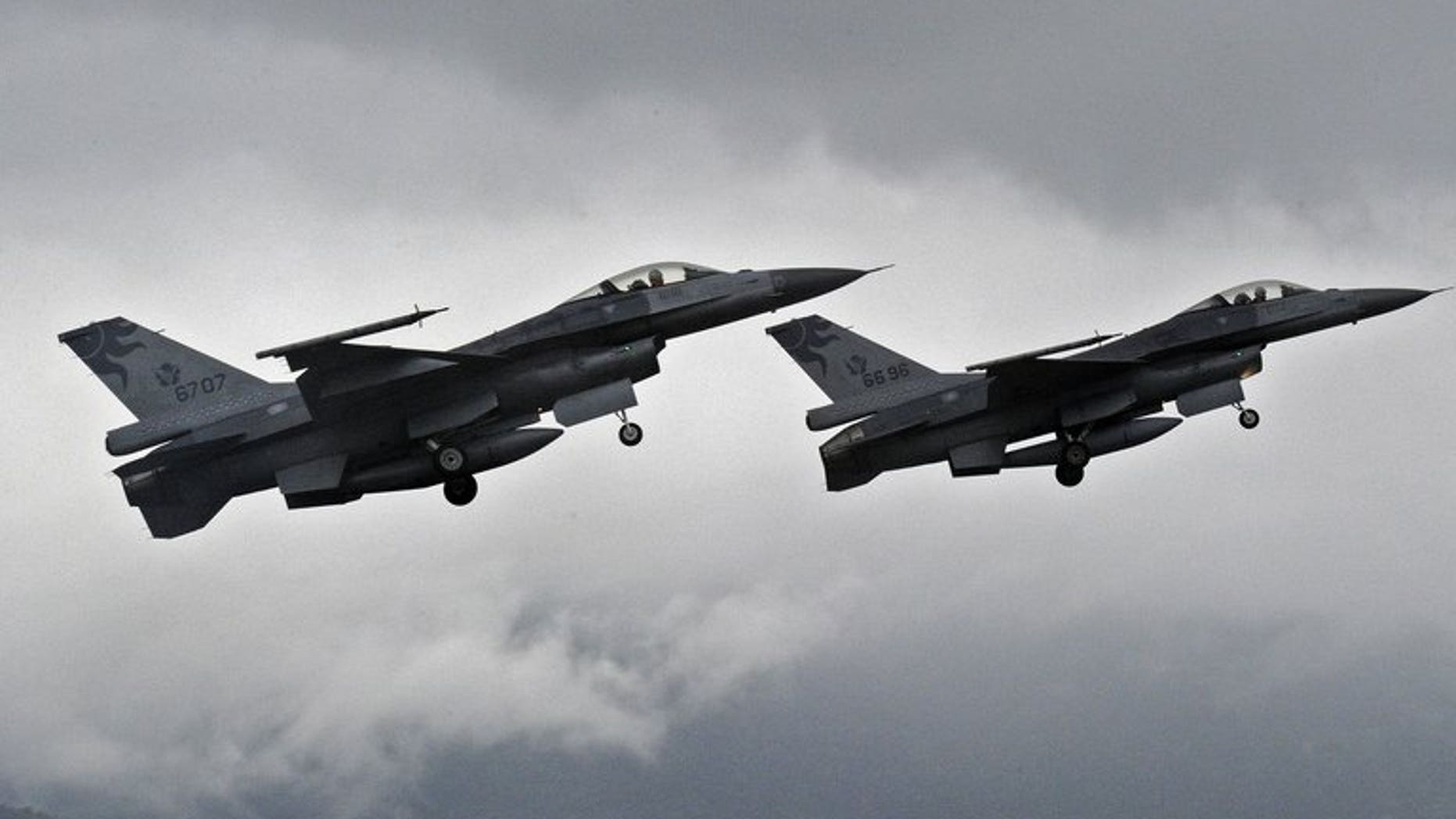 Two F-16 fighters take-off from the Hualien air force base in eastern Taiwan, on January 23, 2013. Taiwan's air force will be armed with "smart" munitions before the year's end that could be used against any Chinese invasion by striking airfields and harbours on the mainland, according to a report in the China Times.