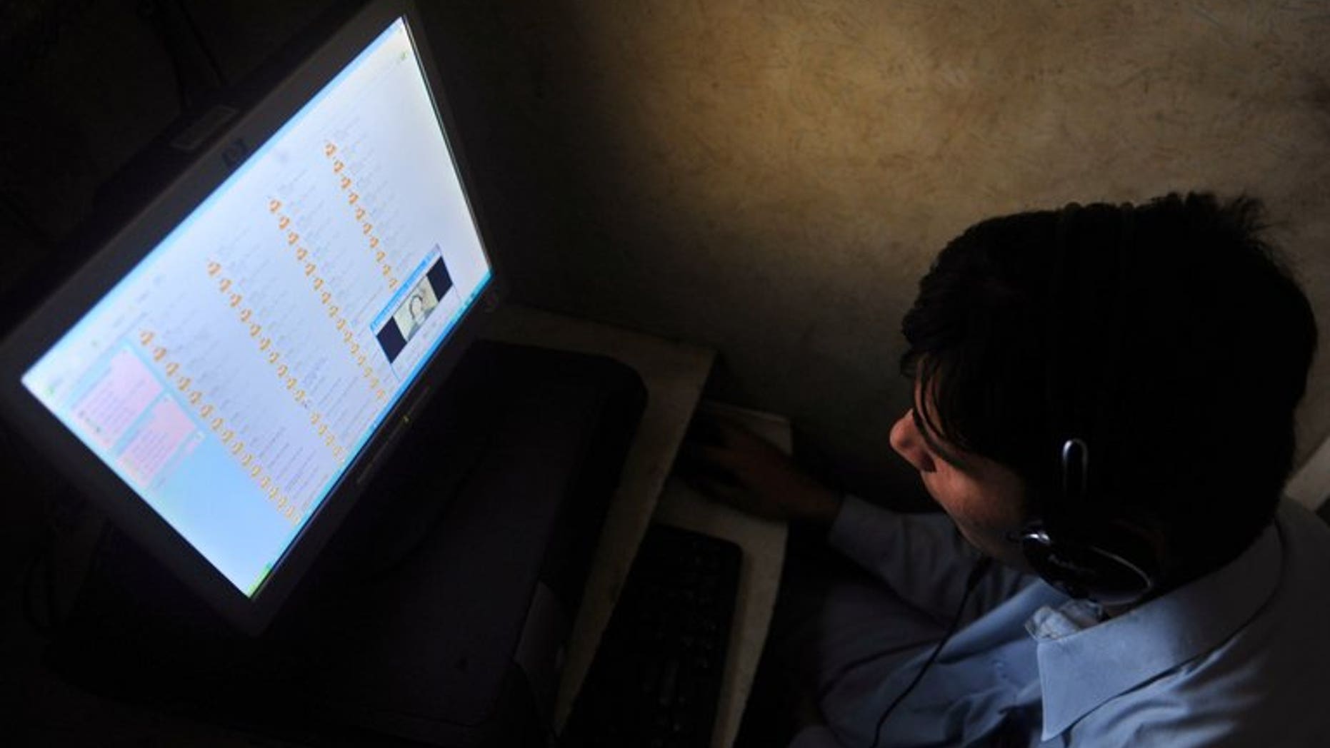 A Pakistani man browses the internat at a cyber cafe in Karachi on May 27, 2010.