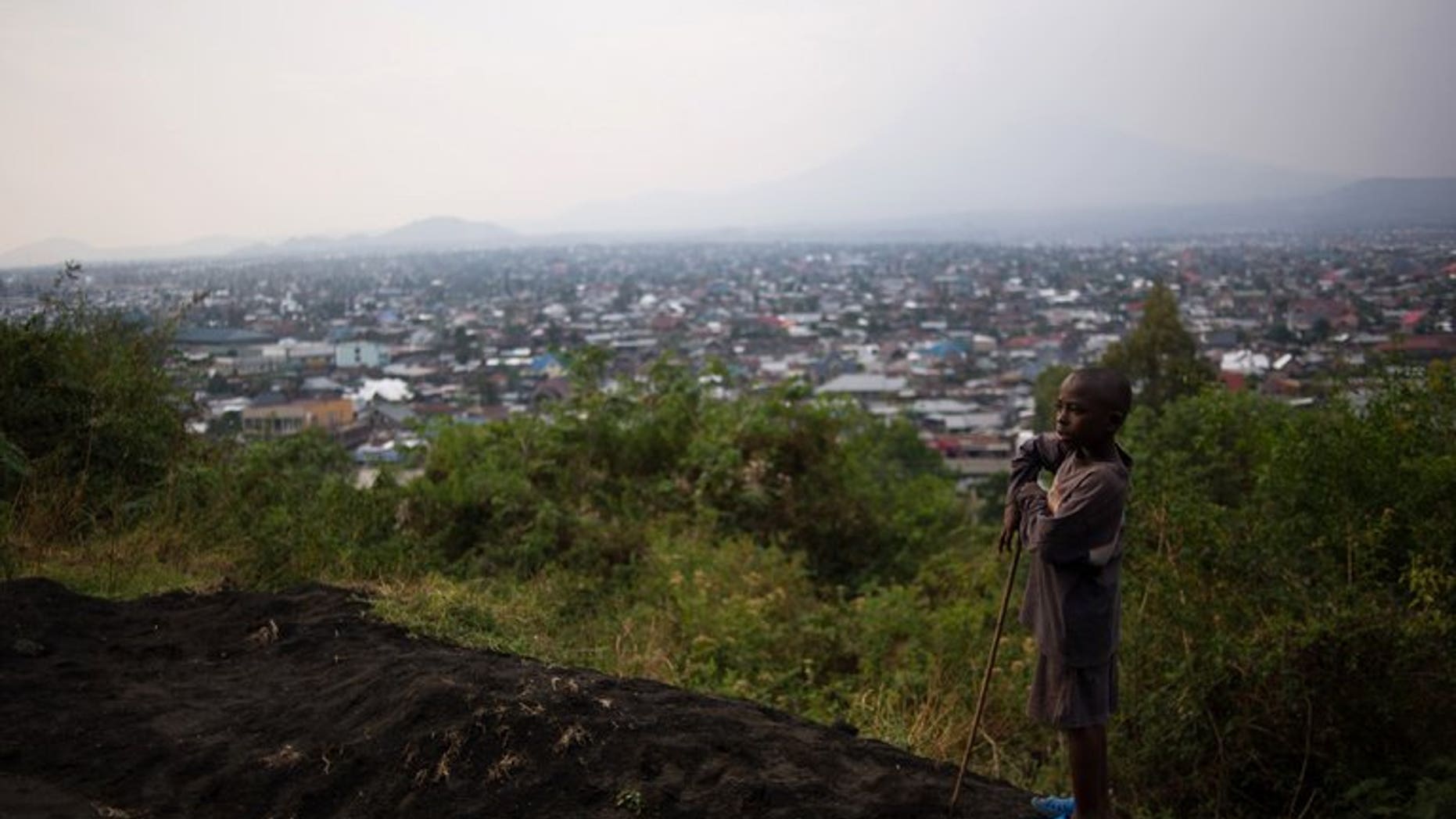 A young boy stands atop Mount Goma overlooking the capital of North Kivu province in the east of the Democratic Republic of the Congo on August 1, 2013.