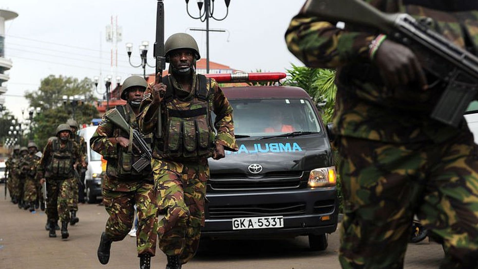 Military personel mobilise on September 21, 2013 outside an upmarket shopping mall in Nairobi.