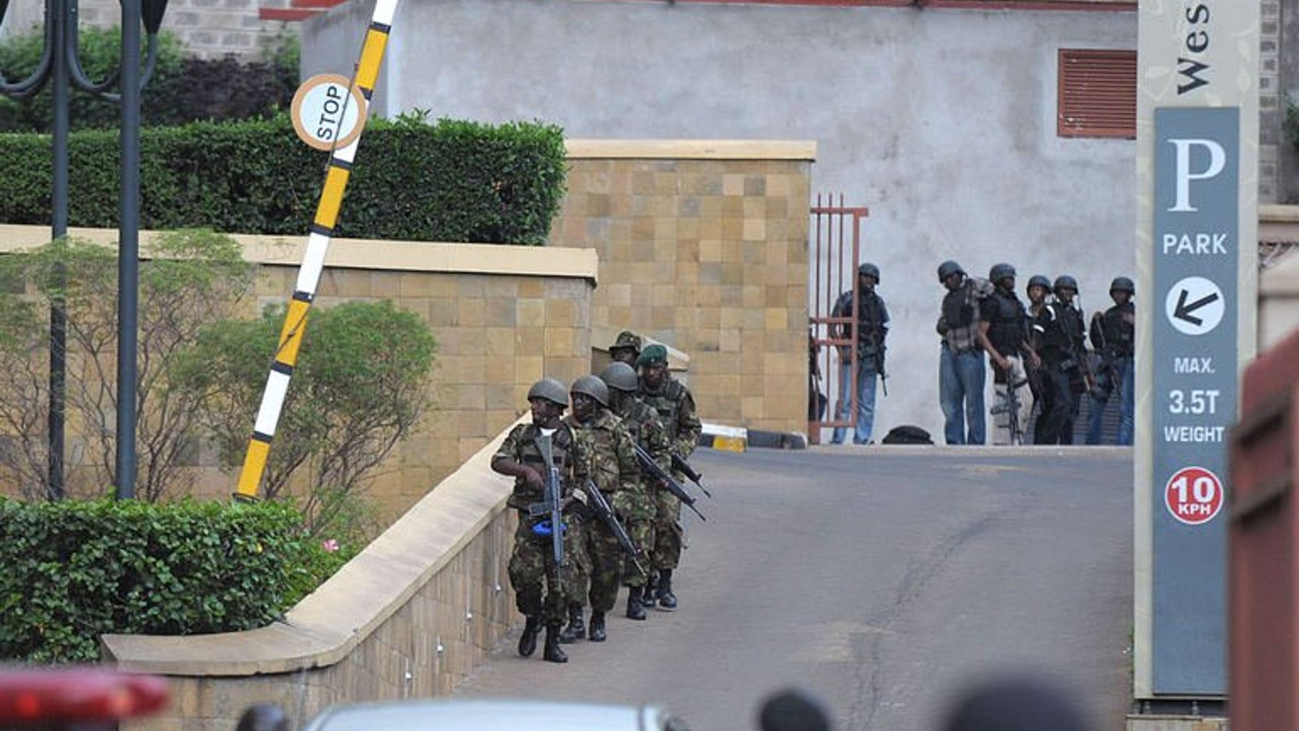 Military personel mobilise on September 21, 2013 outside an upmarket shopping mall in Nairobi.
