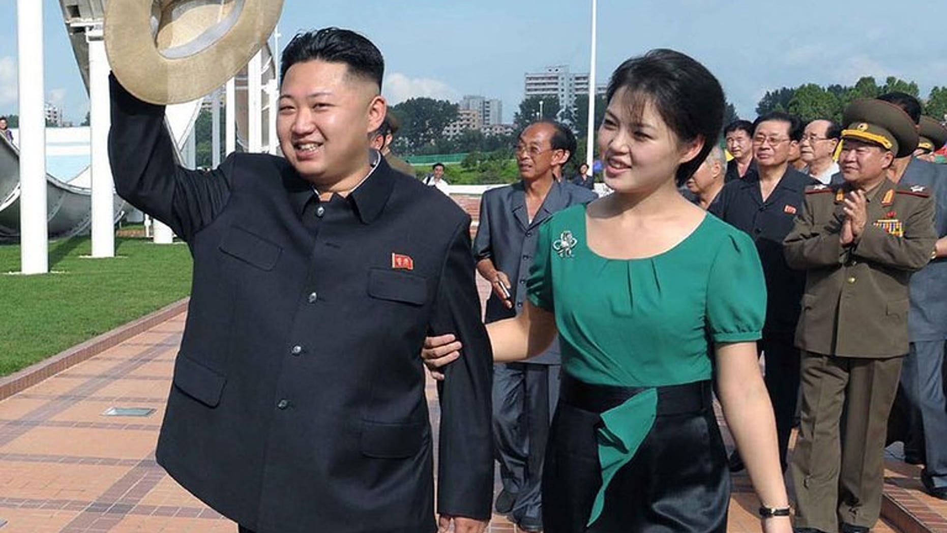 This picture released by North Korea's official Korean Central News Agency (KCNA) via the Korea News Service (KNS) shows North Korean leader Kim Jong-Un and his wife Ri Sol-Ju visiting the Rungna People's Pleasure Ground in Pyongyang, on July 26, 2012. North Korea has angrily denied reports that it had executed several state performers to cover up the past of its first lady.