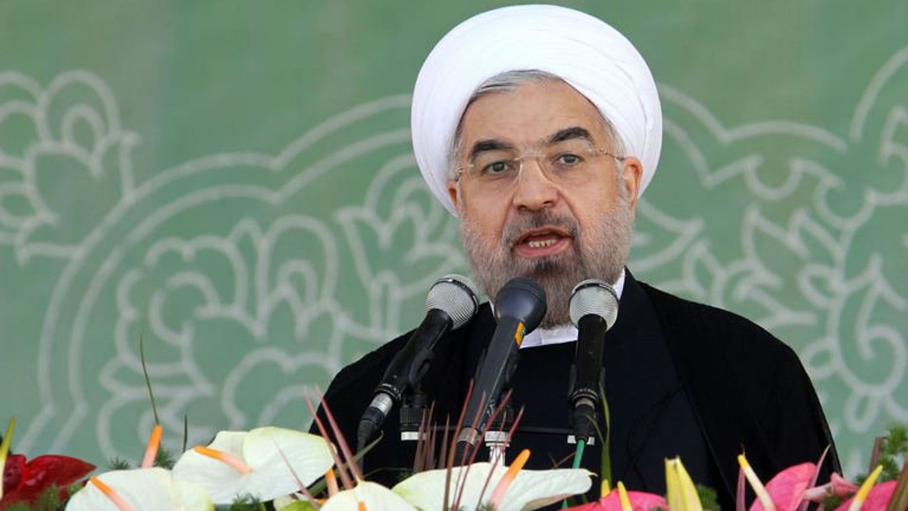 Iraniani President Hassan Rowhani delivers a speech during an annual military parade in Tehran, on September 22, 2013. Rowhani has warned the West it will "regret" any military intervention in Syria, and called for dialogue to stop the war in its ally.