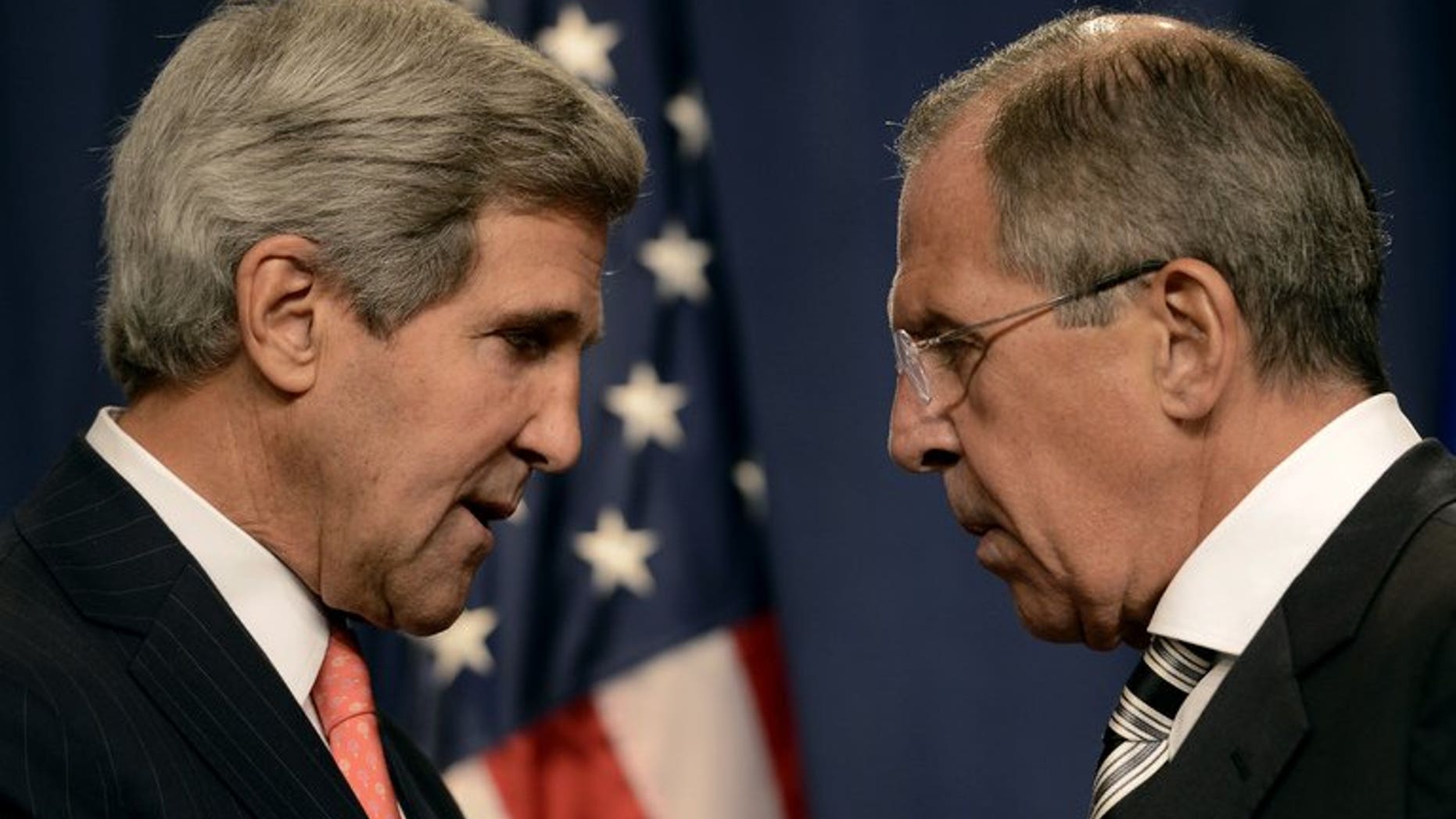US Secretary of State John Kerry (lfet) speaks with Russian Foreign Minister Sergei Lavrov before a press conference in Geneva, on September 14, 2013. Lavrov has accused the United States of blackmailing Russia to support a tough UN resolution against Syria, and said the West is blinded by the idea of regime change in the war-torn country.