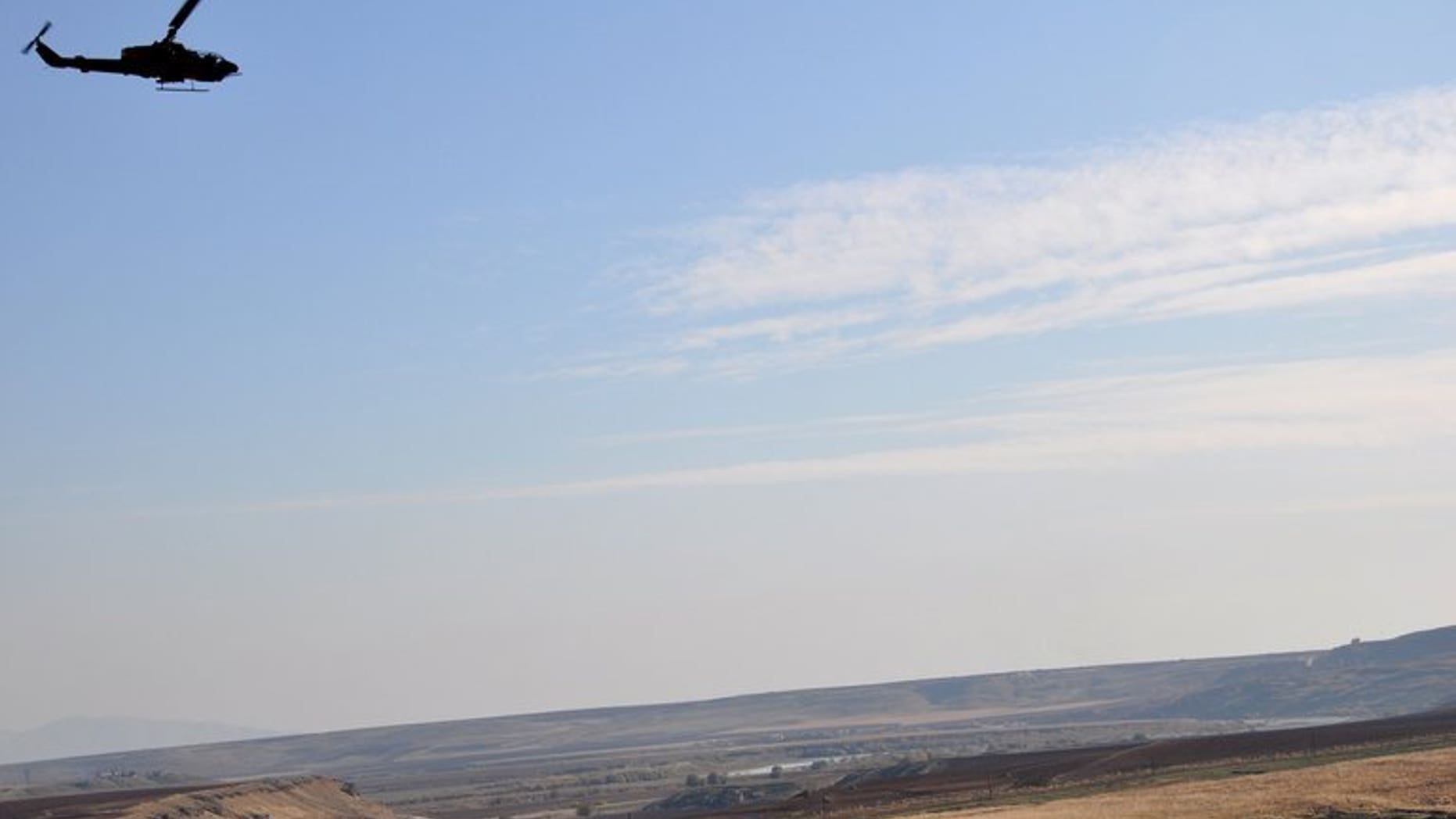 A Turkish helicopter flies near the Turkish-Syrian border village of Katran, on November 28, 2011. Turkey's air force has paid tribute to the crew who shot down a Syrian military helicopter which it said had violated Turkish airspace.