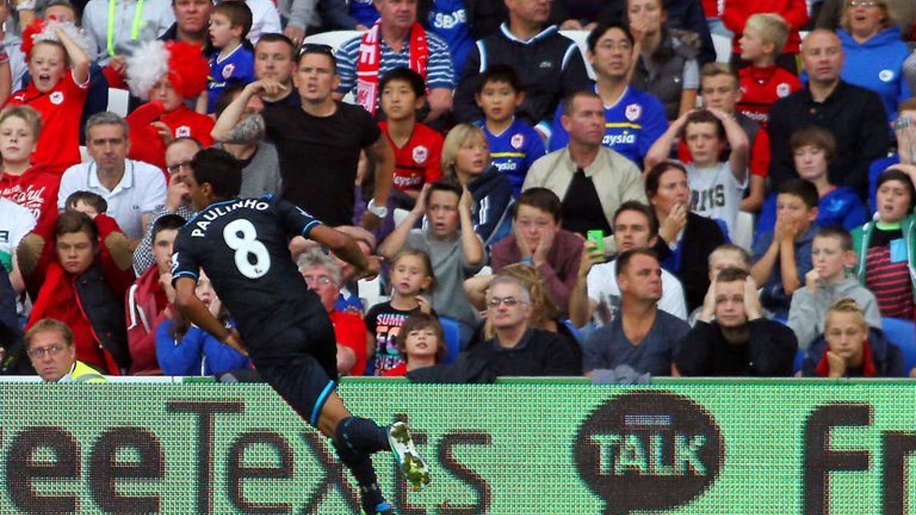 Tottenham Hotspur's Brazilian midfielder Paulinho celebrates scoring his team's opening goal during the English Premier League football match between Cardiff City and Tottenham Hotspur at The Cardiff City Stadium in Cardiff on September 22, 2013. Tottenham won the match 1-0.