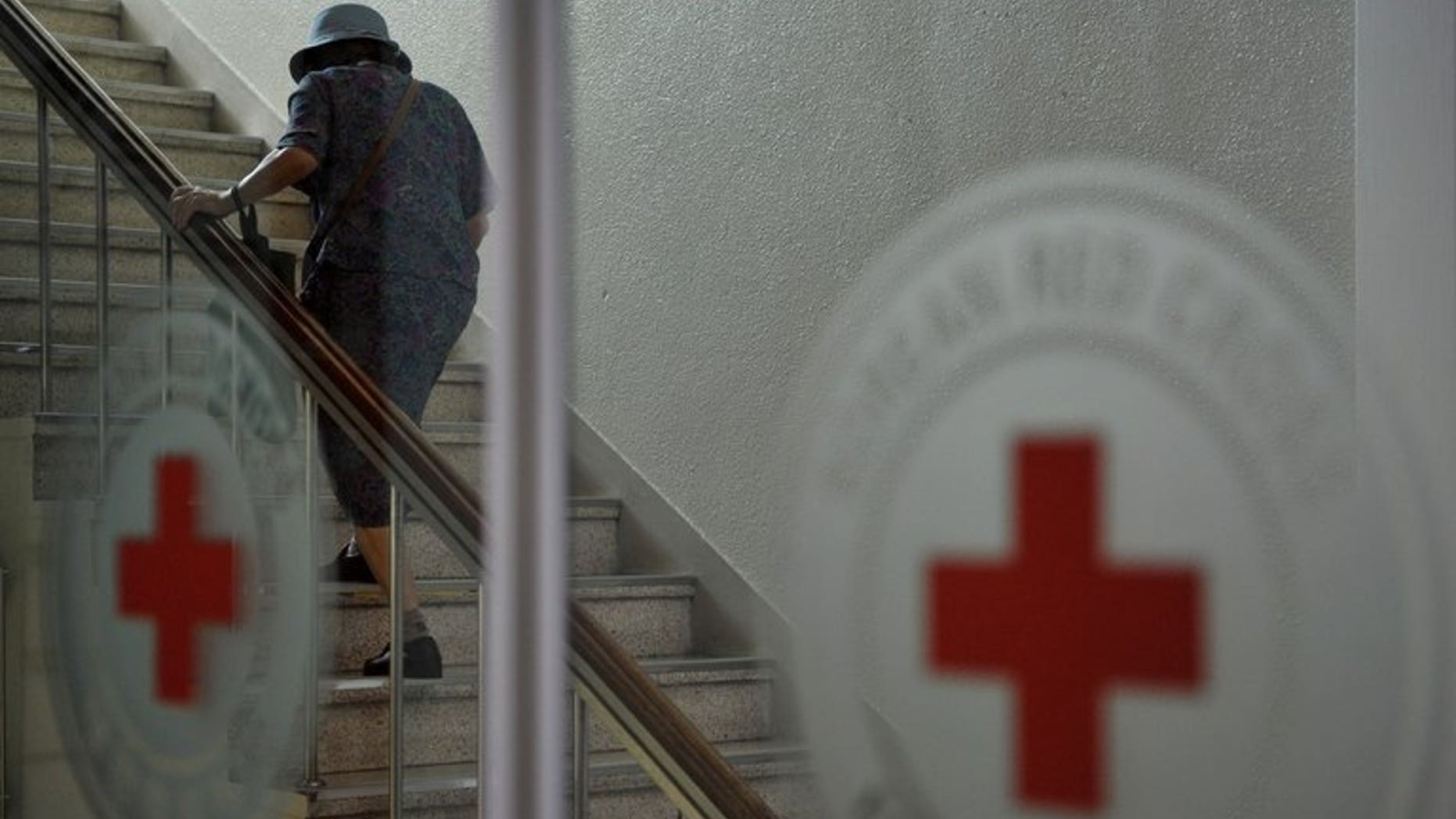 An elderly woman heads to the Red Cross office in Seoul to beg for a place in the family reunions programme, on August 27, 2013. South Korea urged North Korea to review its decision to postpone a reunion for families separated by the Korean War, saying it had "deeply wounded" those chosen to participate.