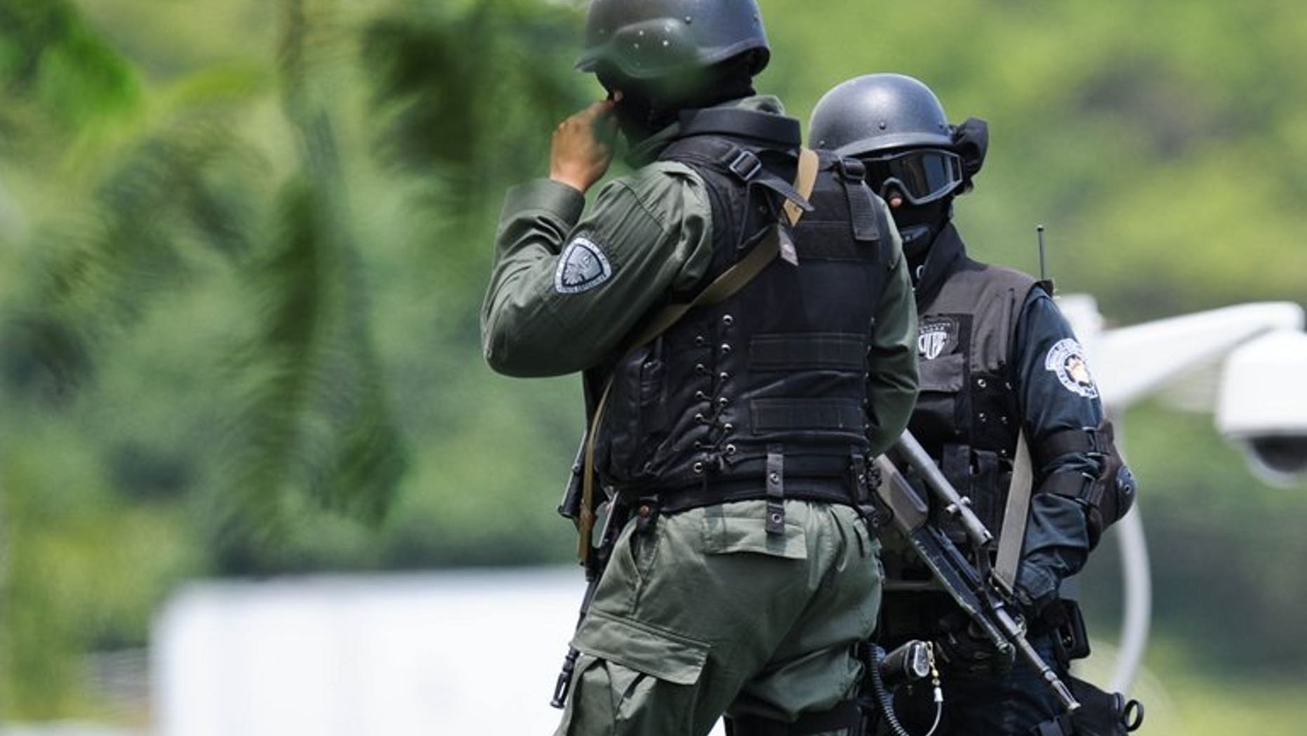 Police stand guard at the airport in Caracas. Three members of Venezuela's security forces have been arrested in connection with the 1.3 tonnes of cocaine French police found aboard an Air France flight that originated in Caracas.