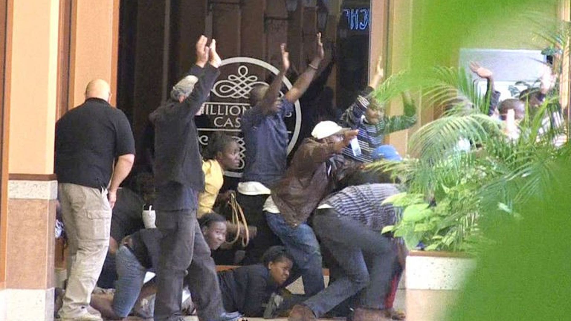 Civilians are evacuated from a shopping mall following an attack by masked gunmen in Nairobi on September 21, 2013. An alleged commander in the Somali Shebab rebel group has denied press reports that Westerners or women were involved in the hostage standoff at a Nairobi mall that has killed at least 69 people.