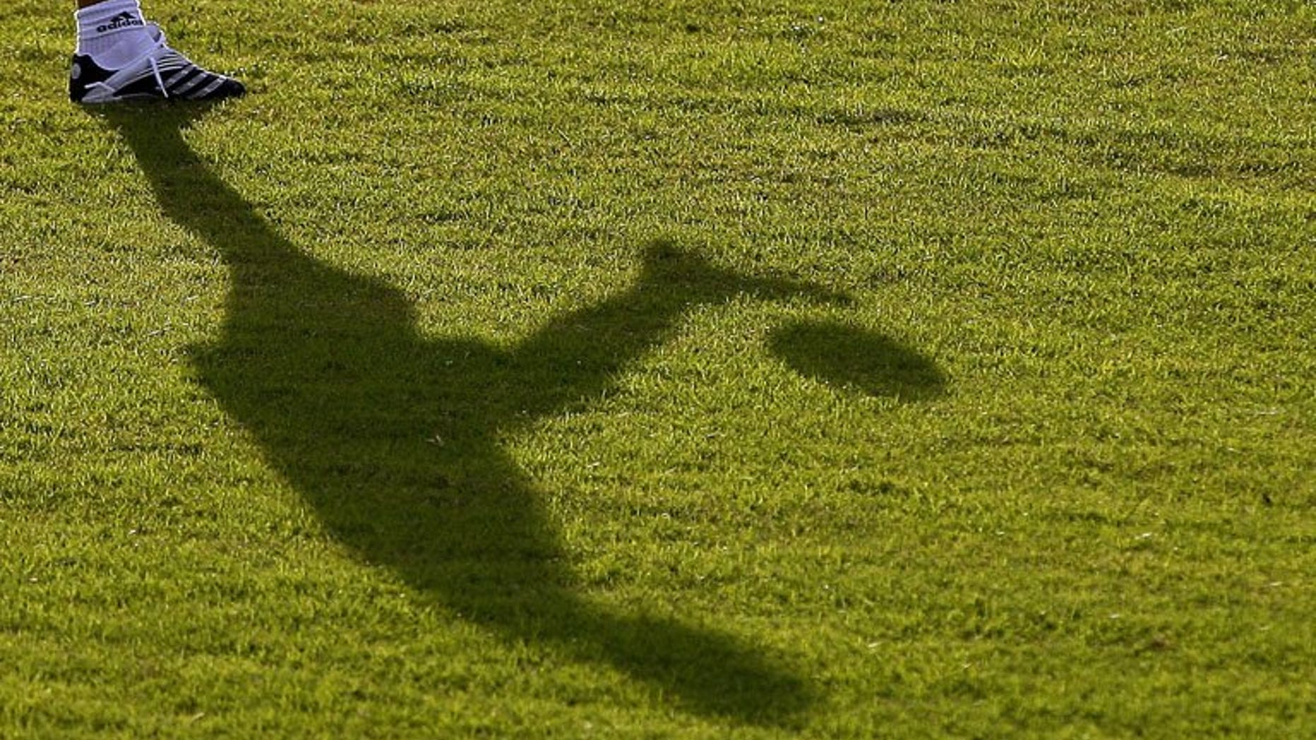 The shadow of a footballer is seen on the field in Barquisimeto, Venezuela on July 6, 2007. A Malaysian football club suspended all of its coaches and officials for two weeks Monday over suspected match-fixing following a series of heavy defeats
