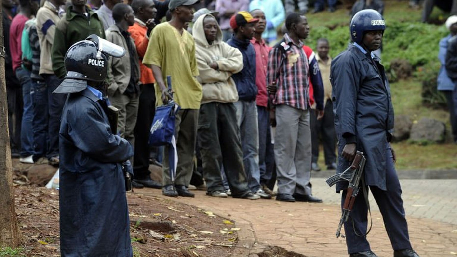 Armed Kenyan policemen keep onlookers away outside the Westgate mall in Nairobi on September 23, 2013. A fourth Briton has been confirmed killed in an attack at the shopping mall staged by Somali Islamist militants, the Foreign Office in London has said.