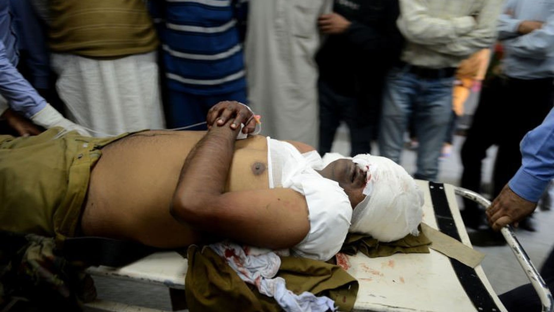 An injured Indian Central Industrial Security Force (CISF) soldier is carried through a hospital in Srinagar on September 23 ,2013. Suspected militants shot and killed a paramilitary soldier and critically wounded another on Monday in a busy market in Indian Kashmir's main city of Srinagar, police said.