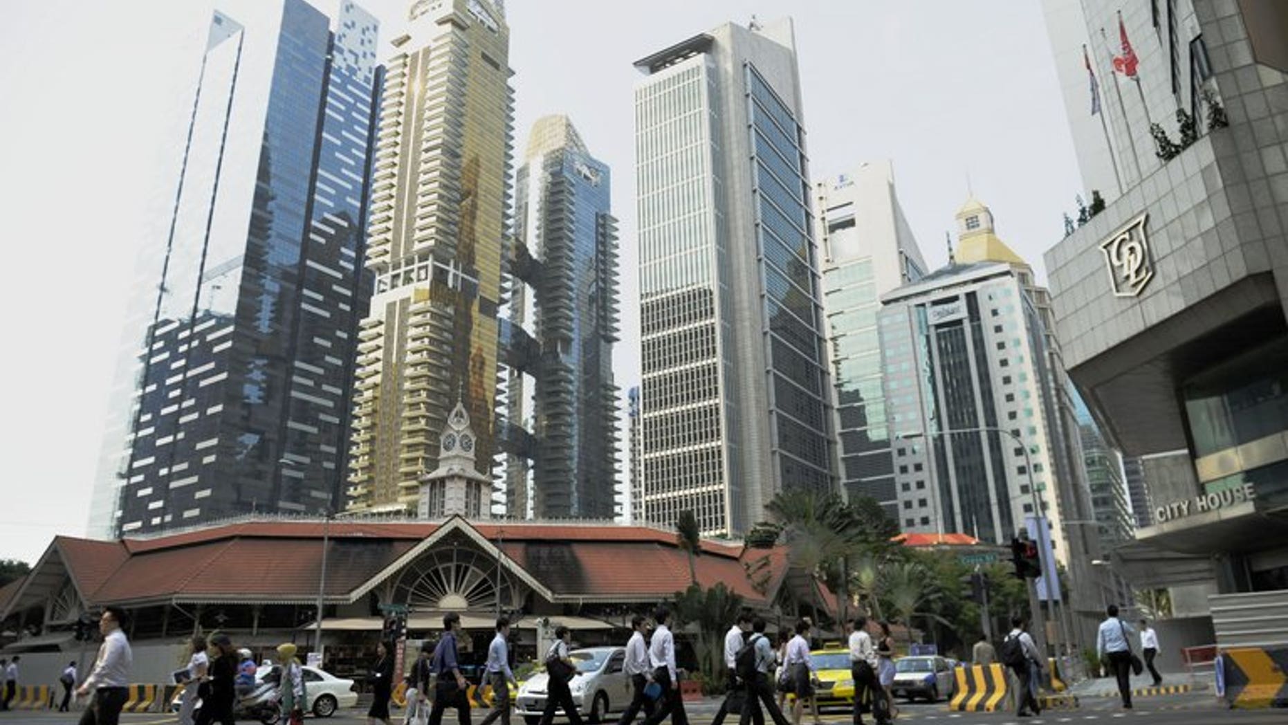 Workers head to work at Singapore's central business district on August 23, 2011. Singapore announced tighter rules on the hiring of foreign professional workers, saying companies will from next year have to show proof they first tried to recruit local citizens