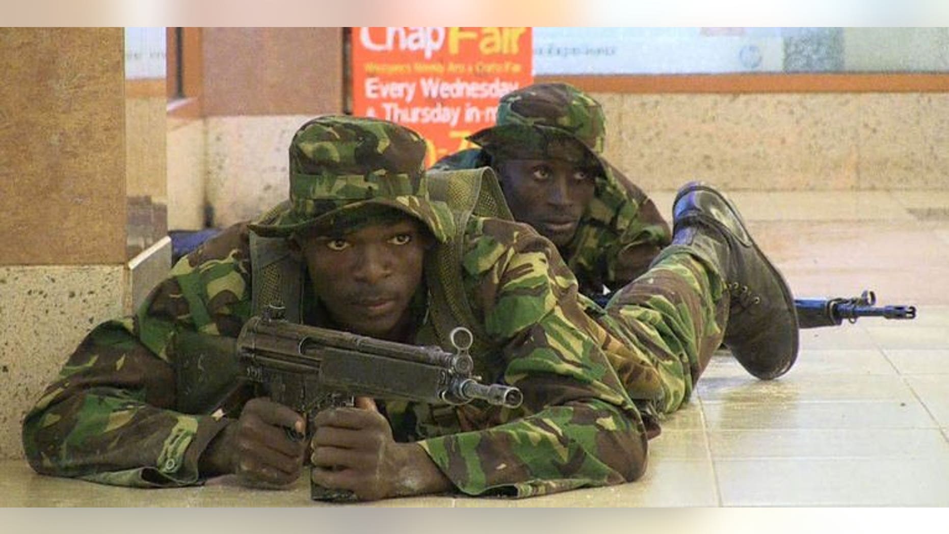 Kenyan troops take position inside the Westgate mall in Nairobi on September 21, 2013. A joint Australian-British architect and his heavily pregnant Dutch wife were named by friends and media as among those killed in the attack.