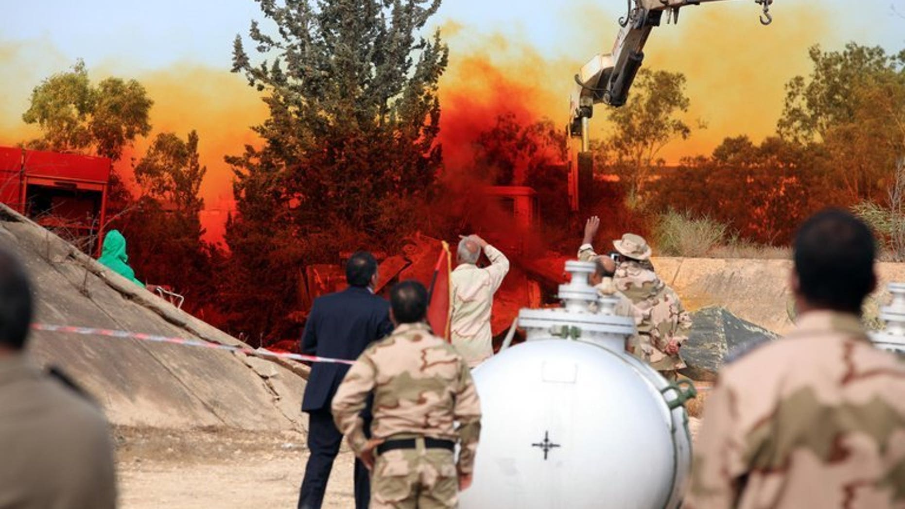 A team of Libyan experts and military engineers monitor a dump tank, under the supervision of the United Nations, in Tripoli on November 11, 2012. Experts were assigned to dump the toxic chemicals found in the air defense missiles and ammunition that was left over from the former Libyan leader Moamer Kadhafi's regime.
