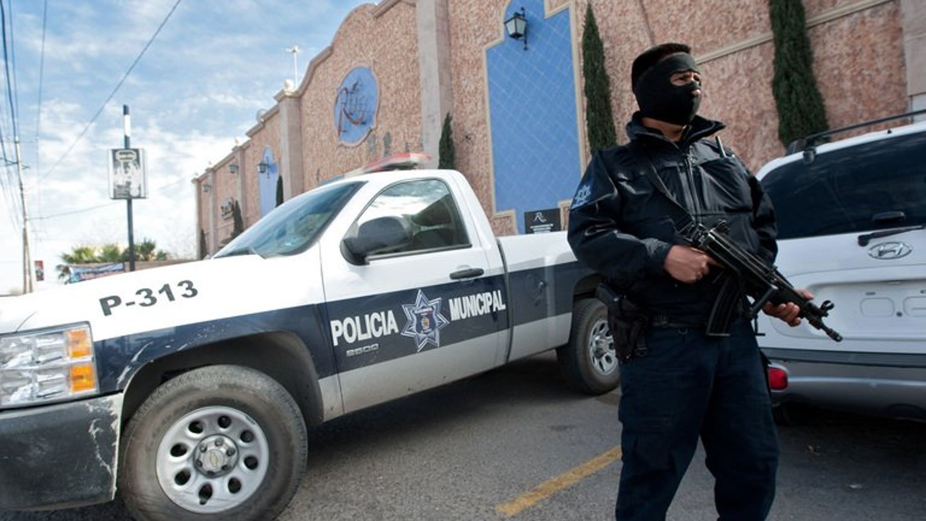 A member of the local police stands guard on January 31, 2012 in Ciudad Juarez. Gunmen armed with assault rifles opened fire on a group of people after an amateur baseball game in northern Mexico, killing 10 including a six-year-old girl, authorities said Monday.