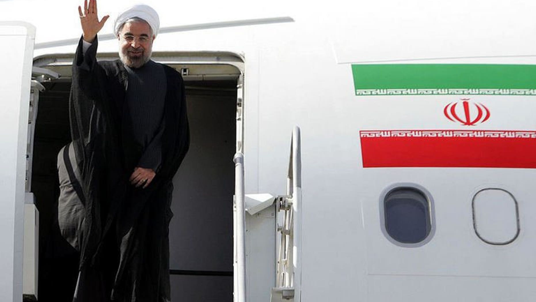 A handout picture released by the Iranian presidency shows President Hassan Rowhani waving before entering an airplane to attend the UN General Assembly, at Tehran's Mehrabad Airport on September 23, 2013.
