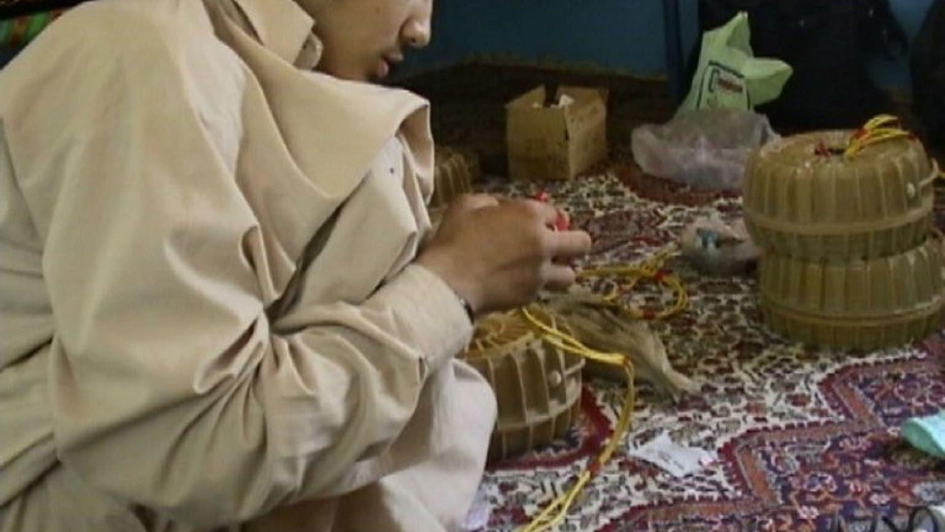 In this image released by the Pentagon on October 31, 2010 shows Canadian Omar Khadr constructing an improvised explosive device.