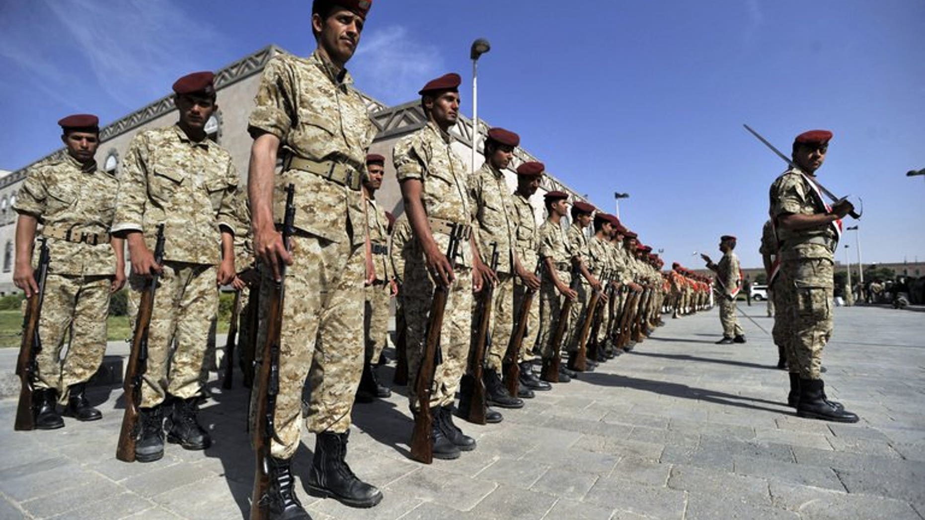 Yemeni soldiers parade during the funeral of victims of bombing attacks on the Gulf of Aden on September 22, 2013 in Sanaa. Unidentified gunmen shot dead on Tuesday a Yemeni air force officer in the capital, the second killing of its kind in less than 24 hours, a military official said.