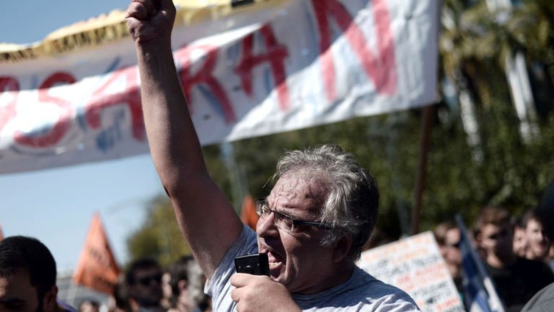A Greek demonstrator shouts slogans during a rally in Athens, on September 24, 2013. Thousands of Greek civil servants have protested at the start of a fresh strike against job cuts pushed by the government in return for international bailout loans.